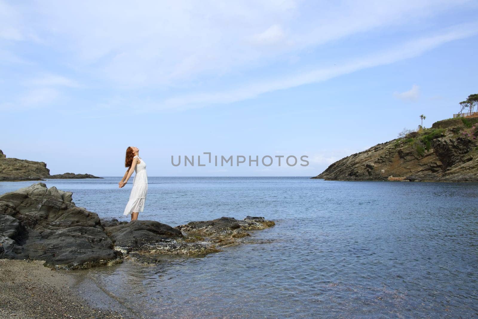 Full body of a lady breathing fresh air on the beach
