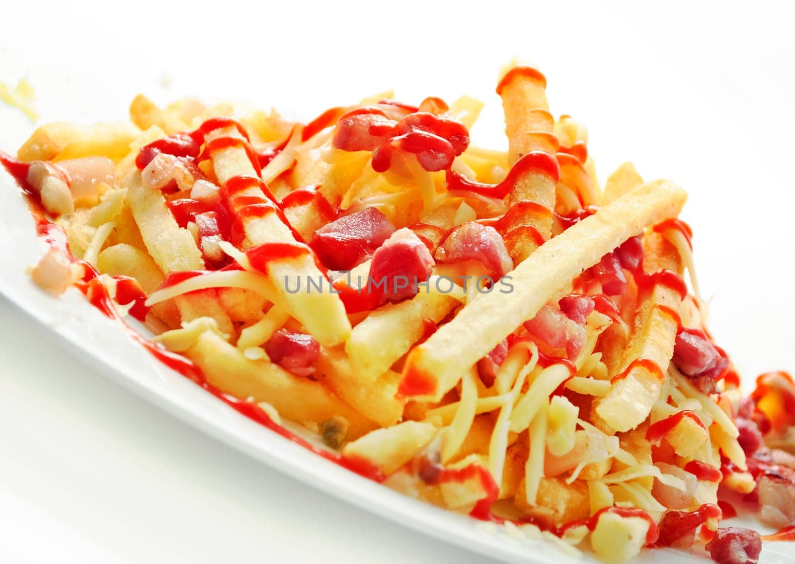 Delicious french fries with bacon on white background