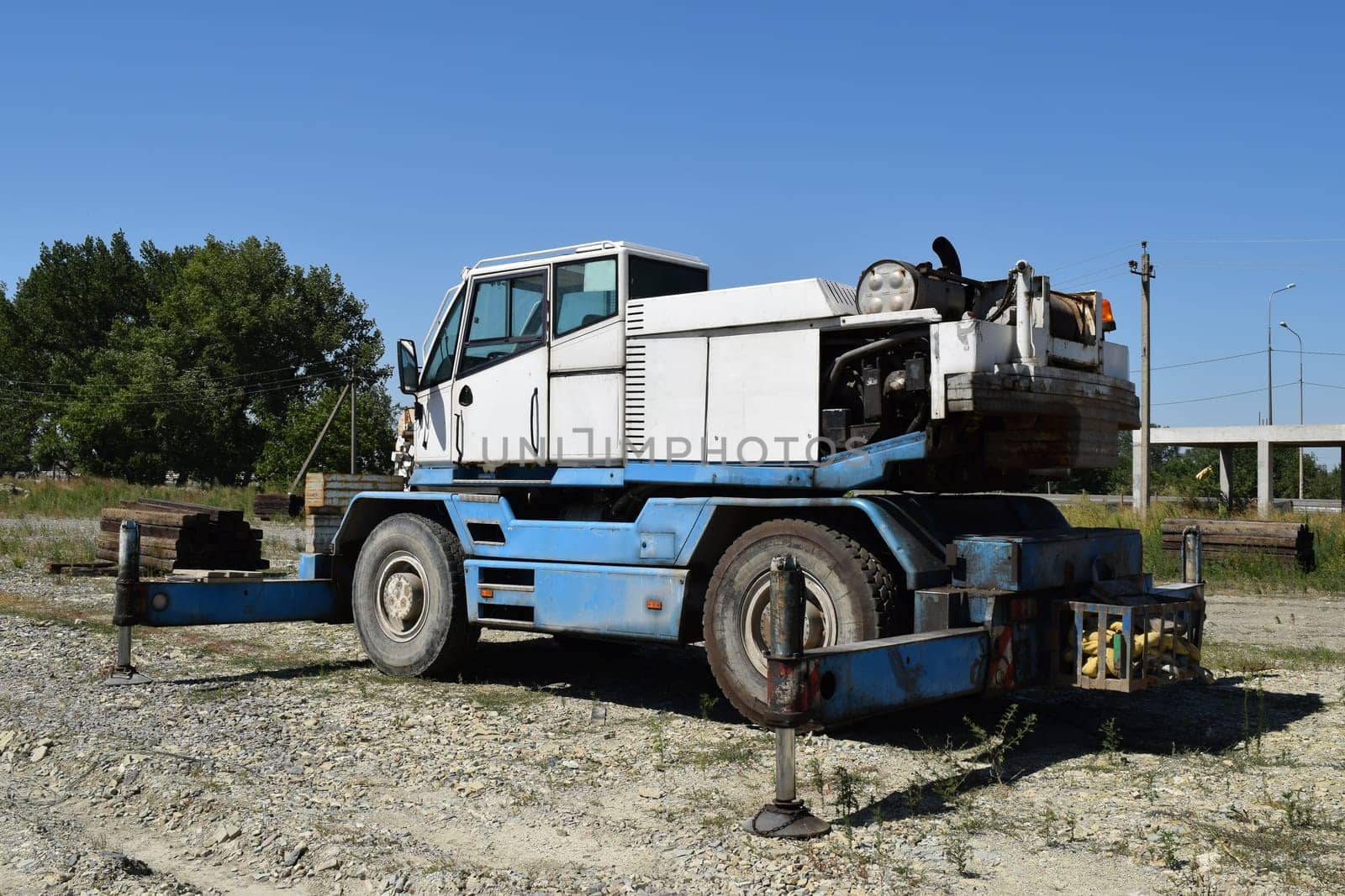 The disassembled loader crane. Old machinery repair.