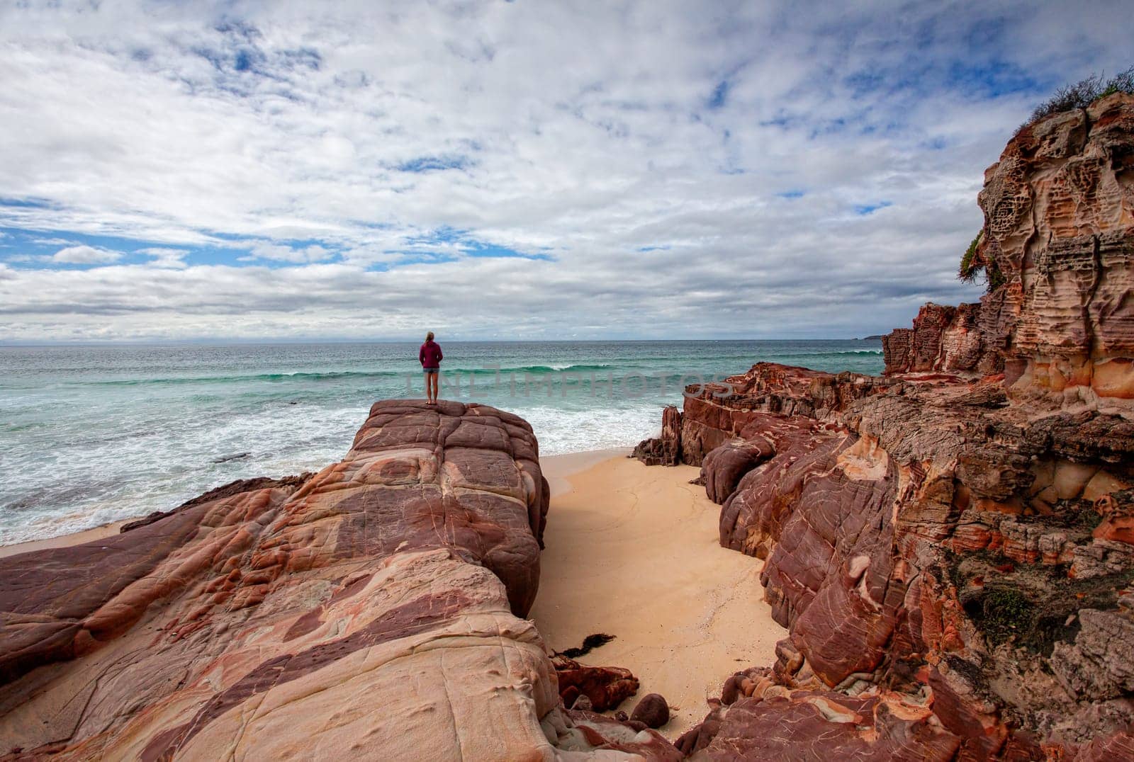 Iron rich red rocks with sandstone offer a dramatic landscape along the coastline and  beaches along the sapphire coast of far New South Wales