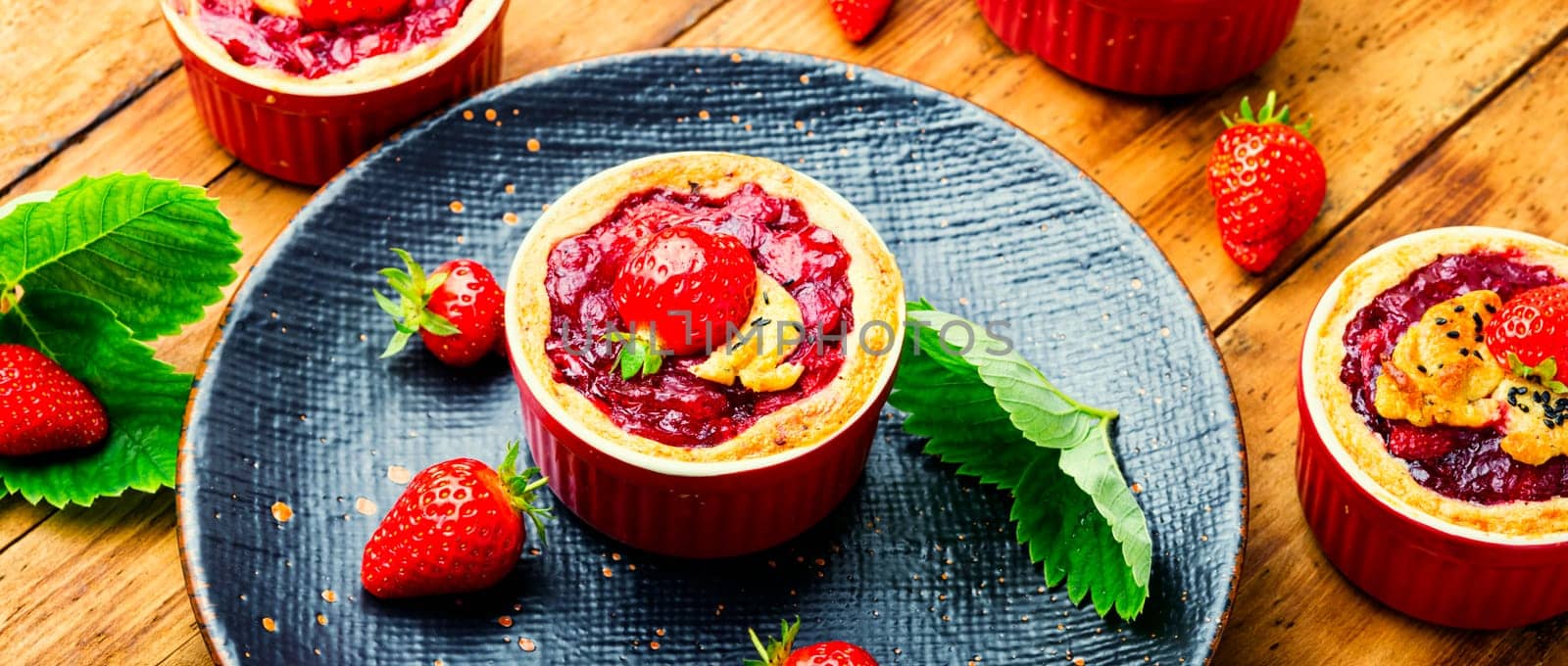 Strawberry shortcake pies on the plate.Tasty tartlets with fresh strawberries.Sweet dessert
