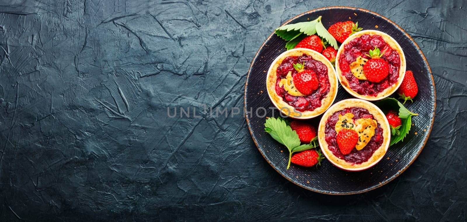 Strawberry shortcake pies on the plate.Tasty tartlets with fresh strawberries.Sweet dessert