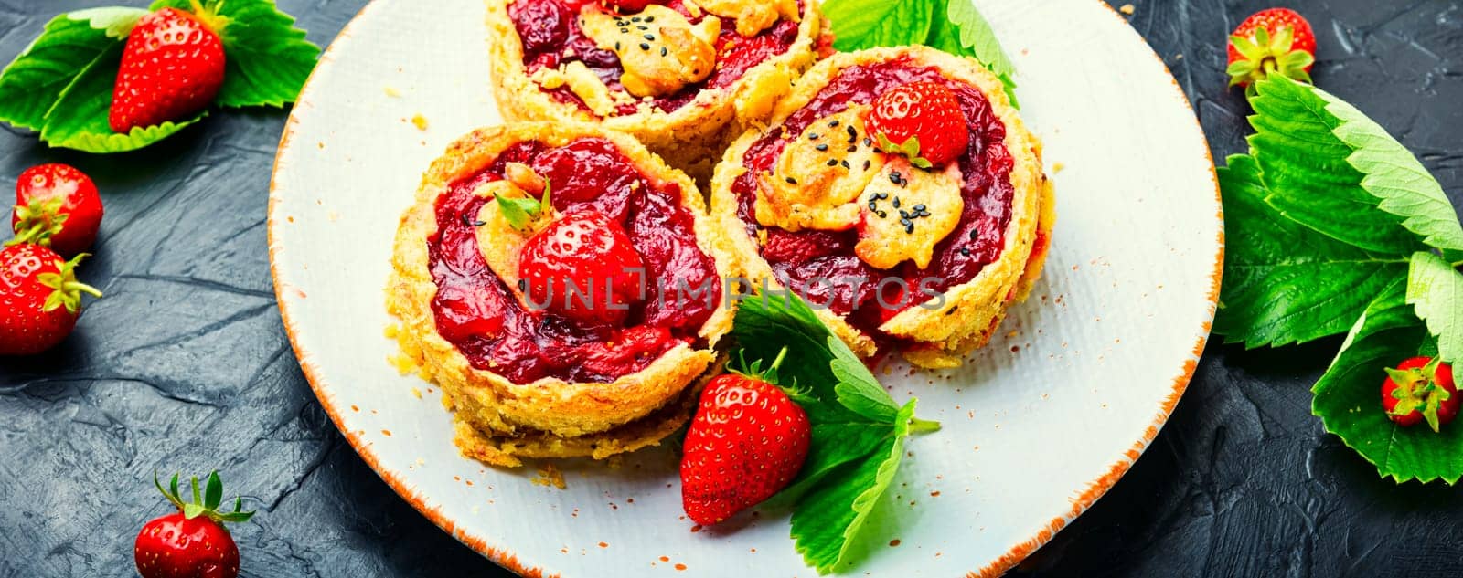 Strawberry shortcake pies on the plate.Tasty tartlets with fresh strawberries.Sweet dessert