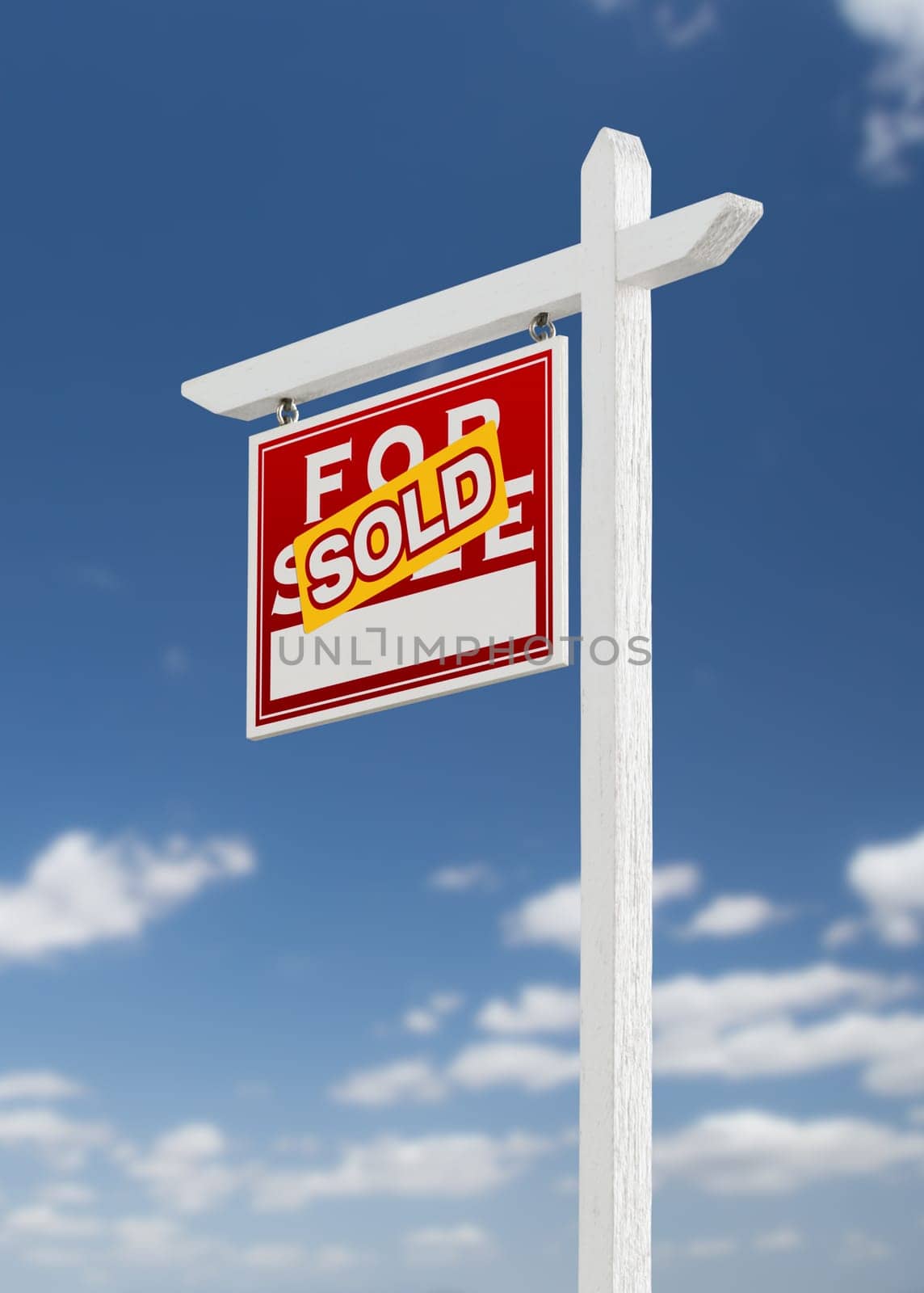 Left Facing Sold For Sale Real Estate Sign on a Blue Sky with Clouds.