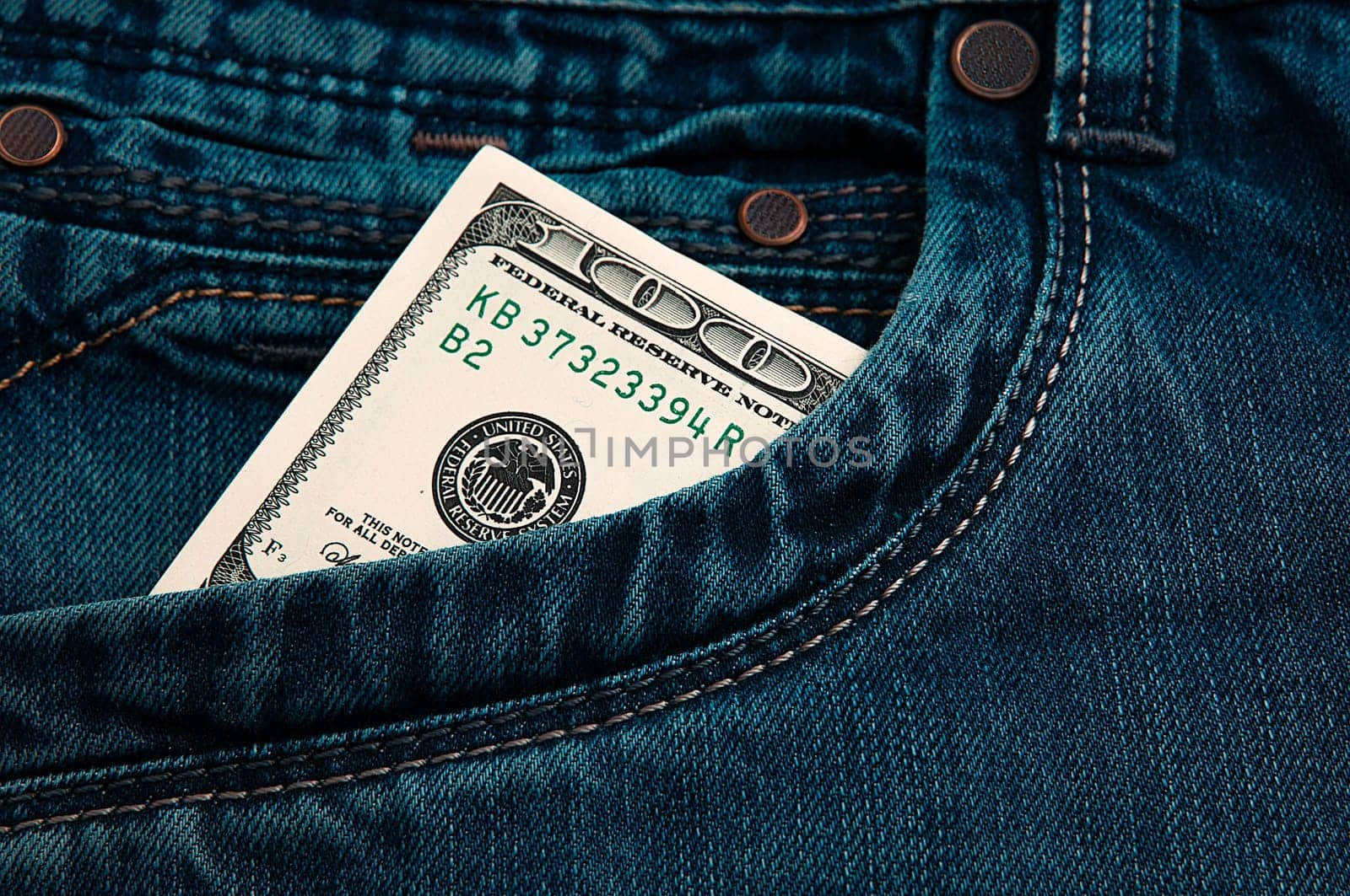 A hundred-dollar bill in the pocket of his jeans. The one hundred American dollar bill is sticking out. One bill is US dollars. Color style.