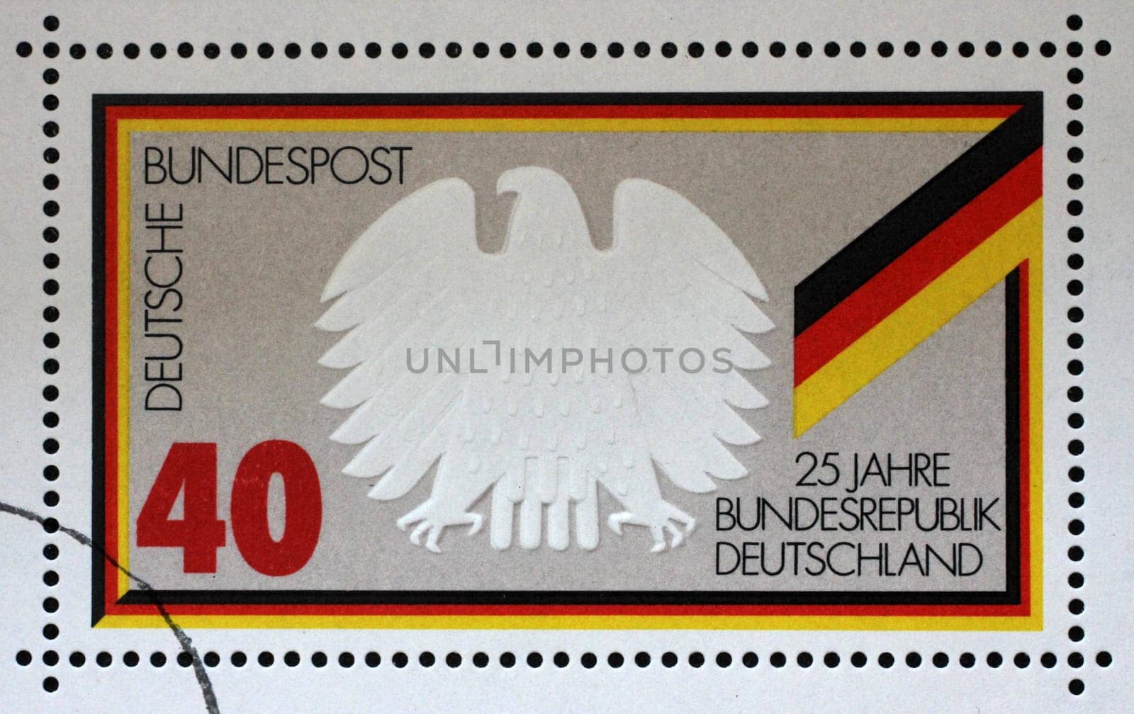 A stamp printed in Germany shows Federal Eagle and Flag, 25 years Federal Republic of Germany, circa 1974