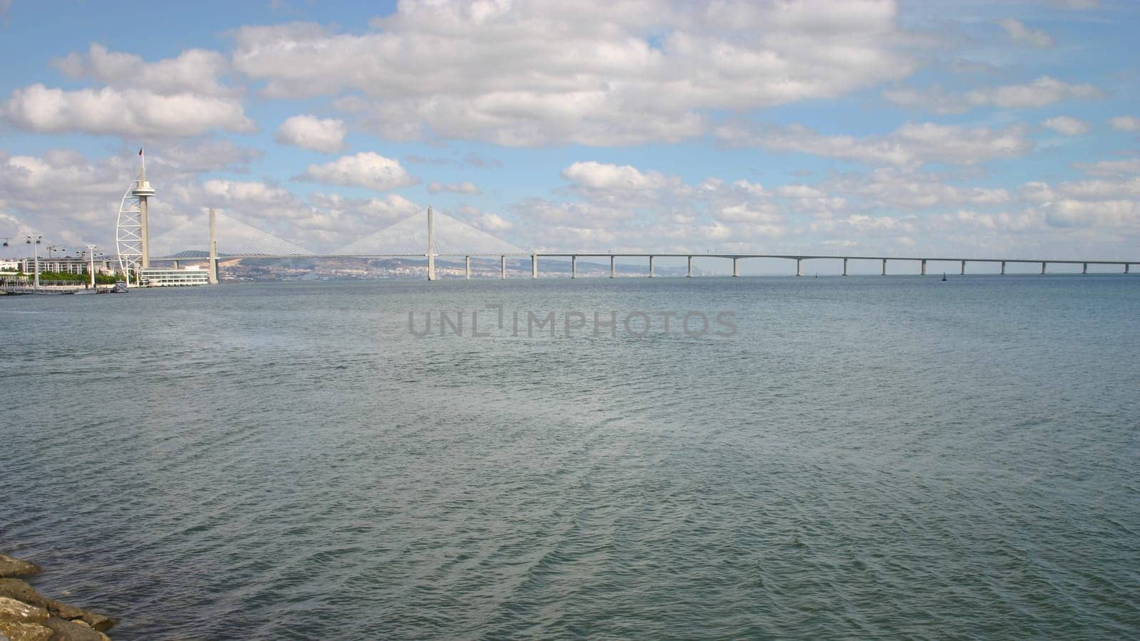 Lisbon, Portugal - September 18, 2006: Vasco da Gama tower and bridge over river Tagus on a sunny day.