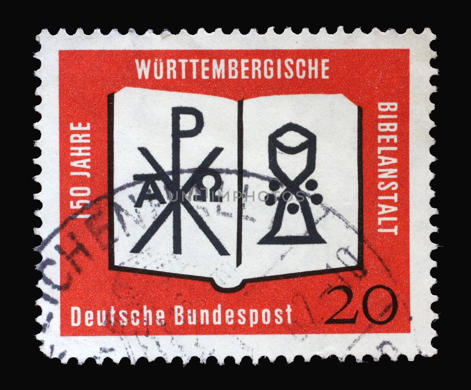 Stamp printed in Germany showing an open Bible with a monogram of Christ and a chalice. 150 years of the Württemberg Bible Institute, circa 1962