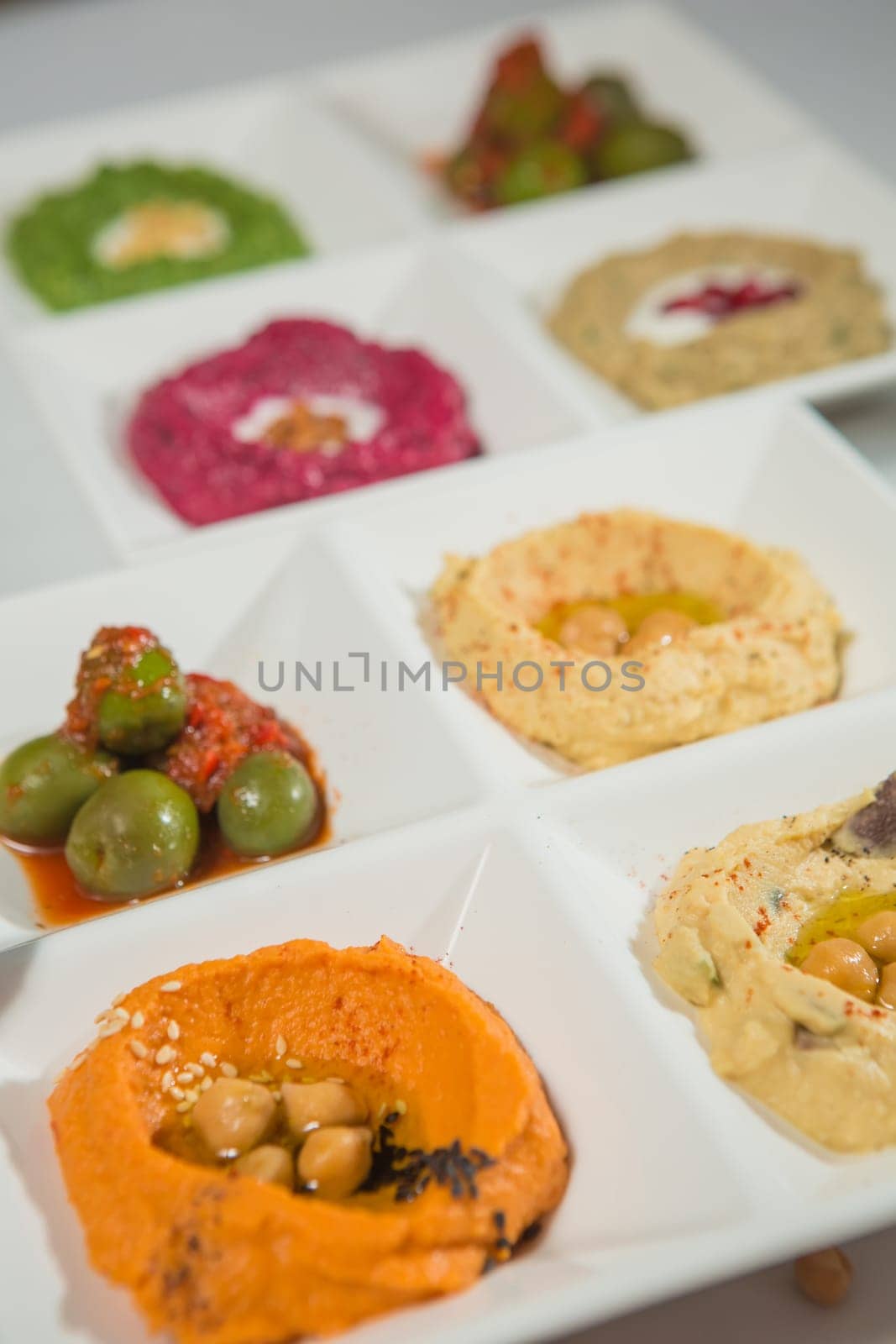 Delicious and healthy hummus set in white pate.