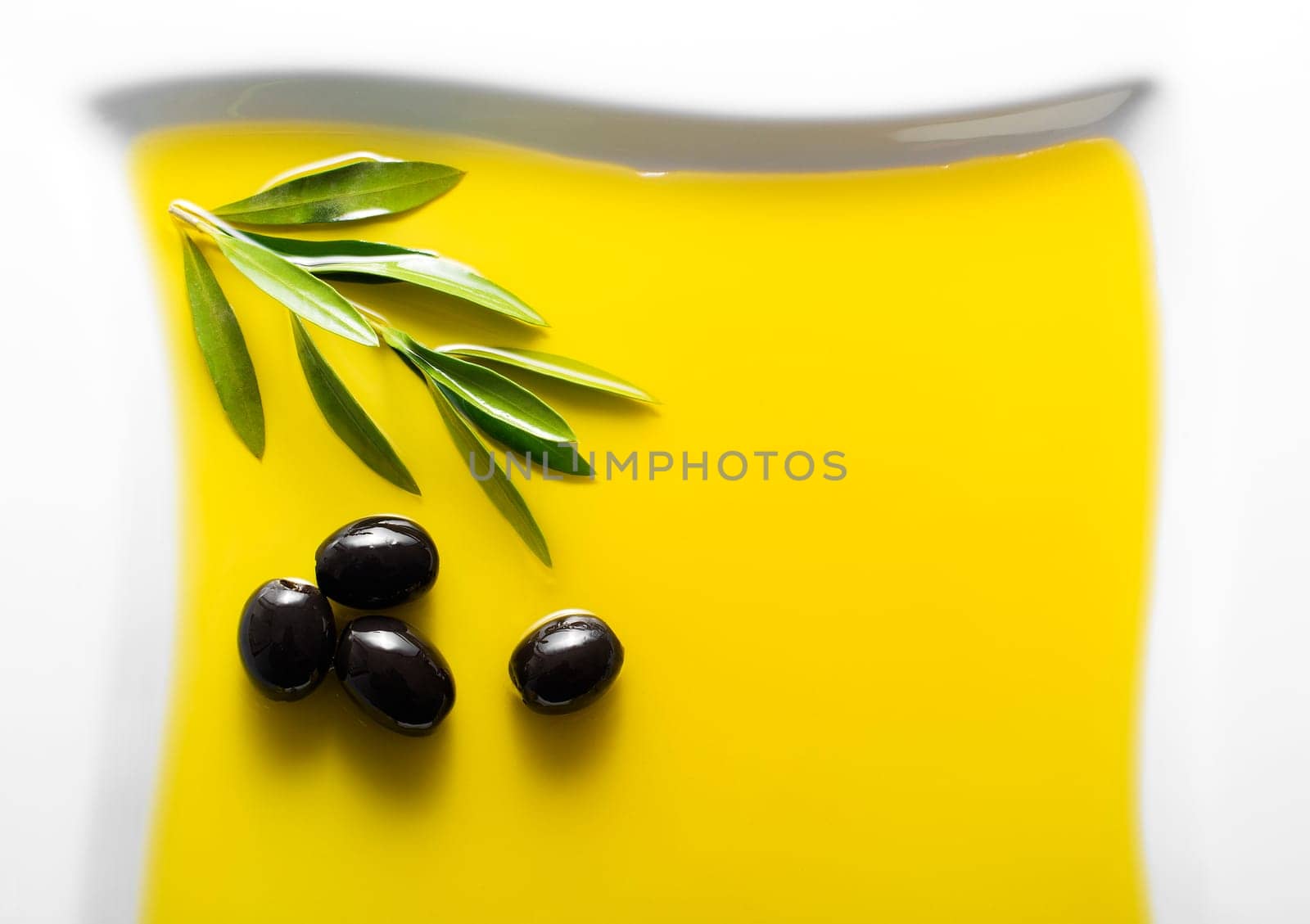 Olive fruit in oil background close up