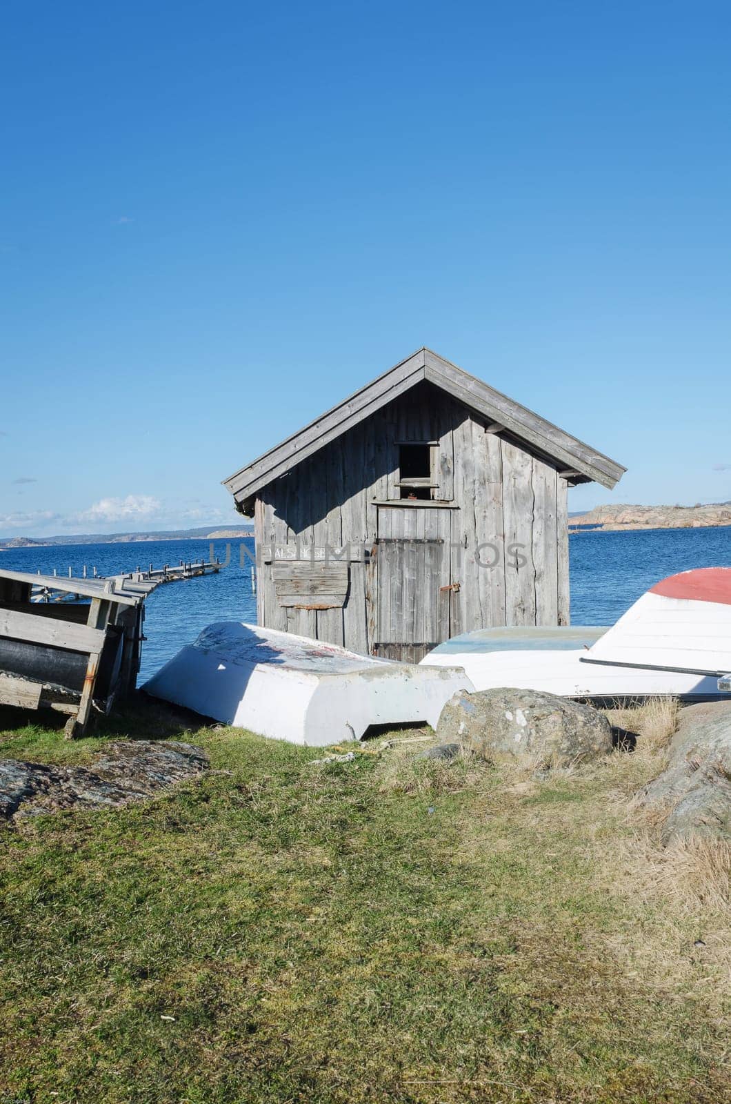 old boathouse with small boat on the outside