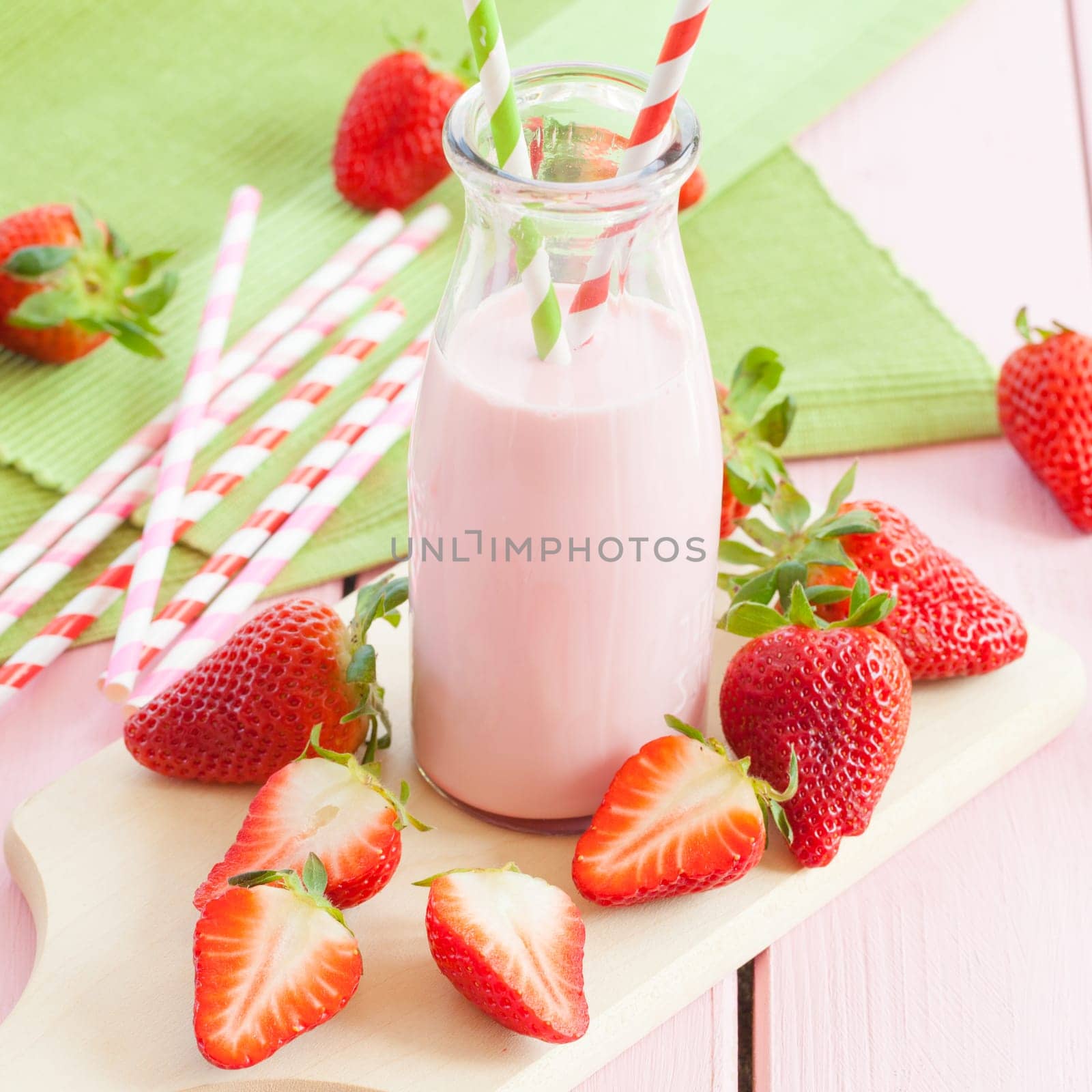 Vintage bottle of milk with fresh strawberries