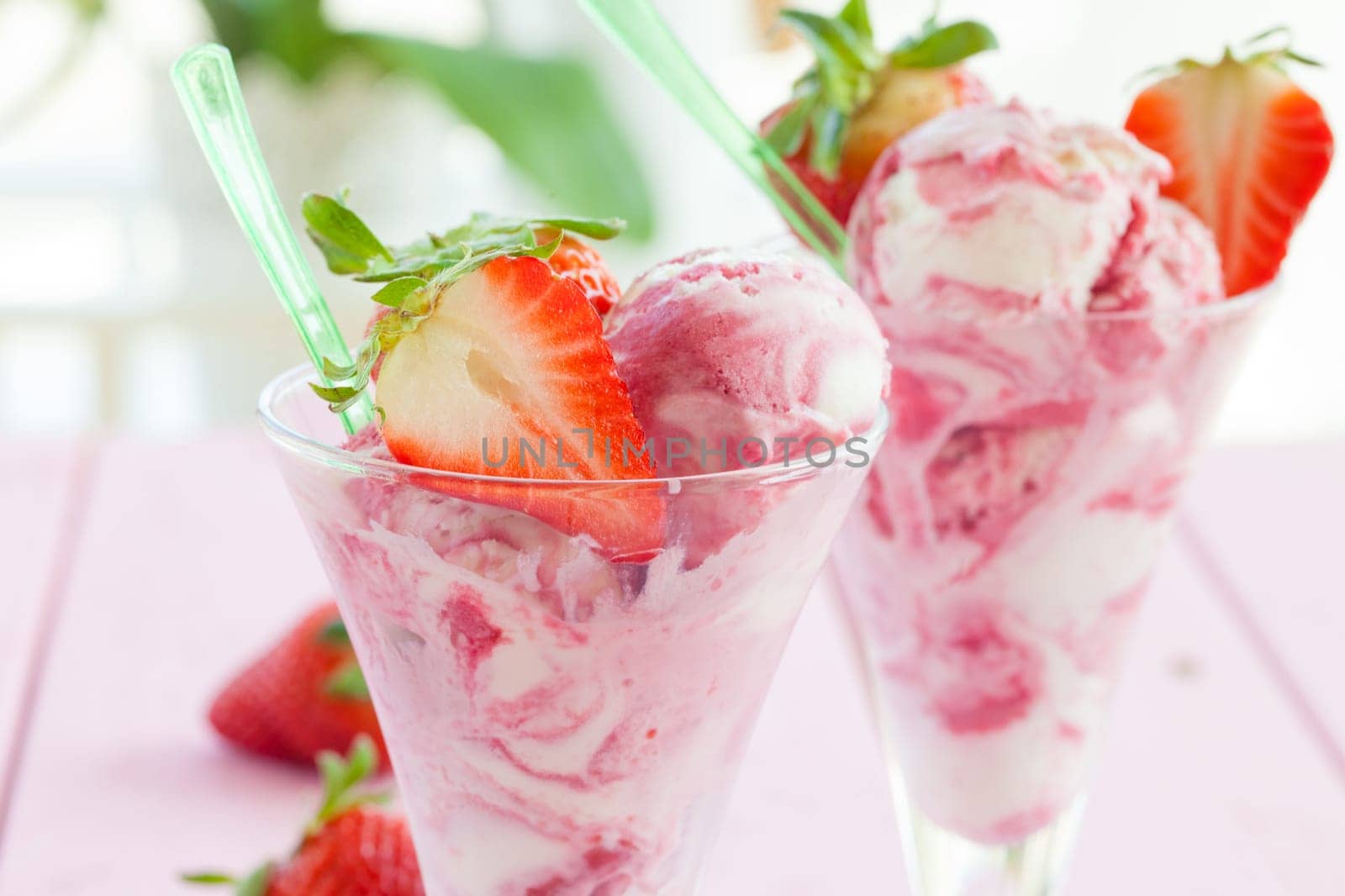 Milk ice cream with fresh strawberries on pink rustic background