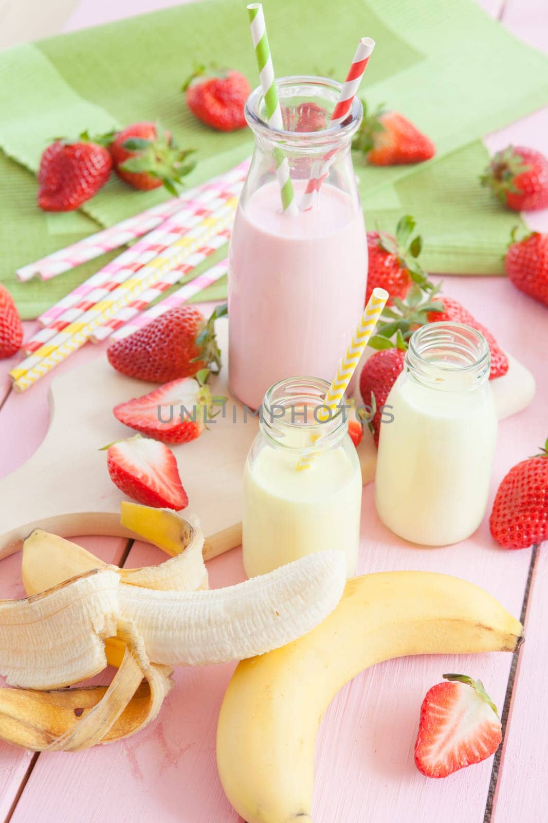Vintage bottles of milk with fresh strawberries and banana