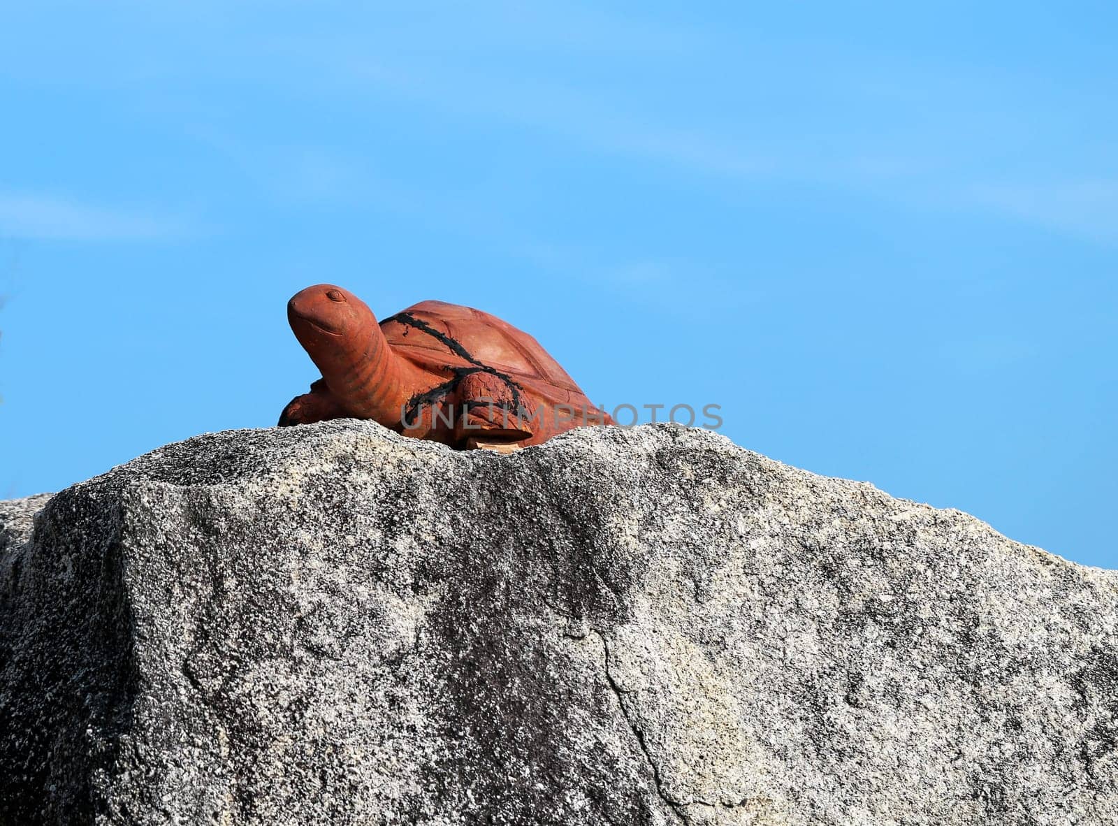 Rock with a statue of a turtle on the beach in Thailand on Koh Samui