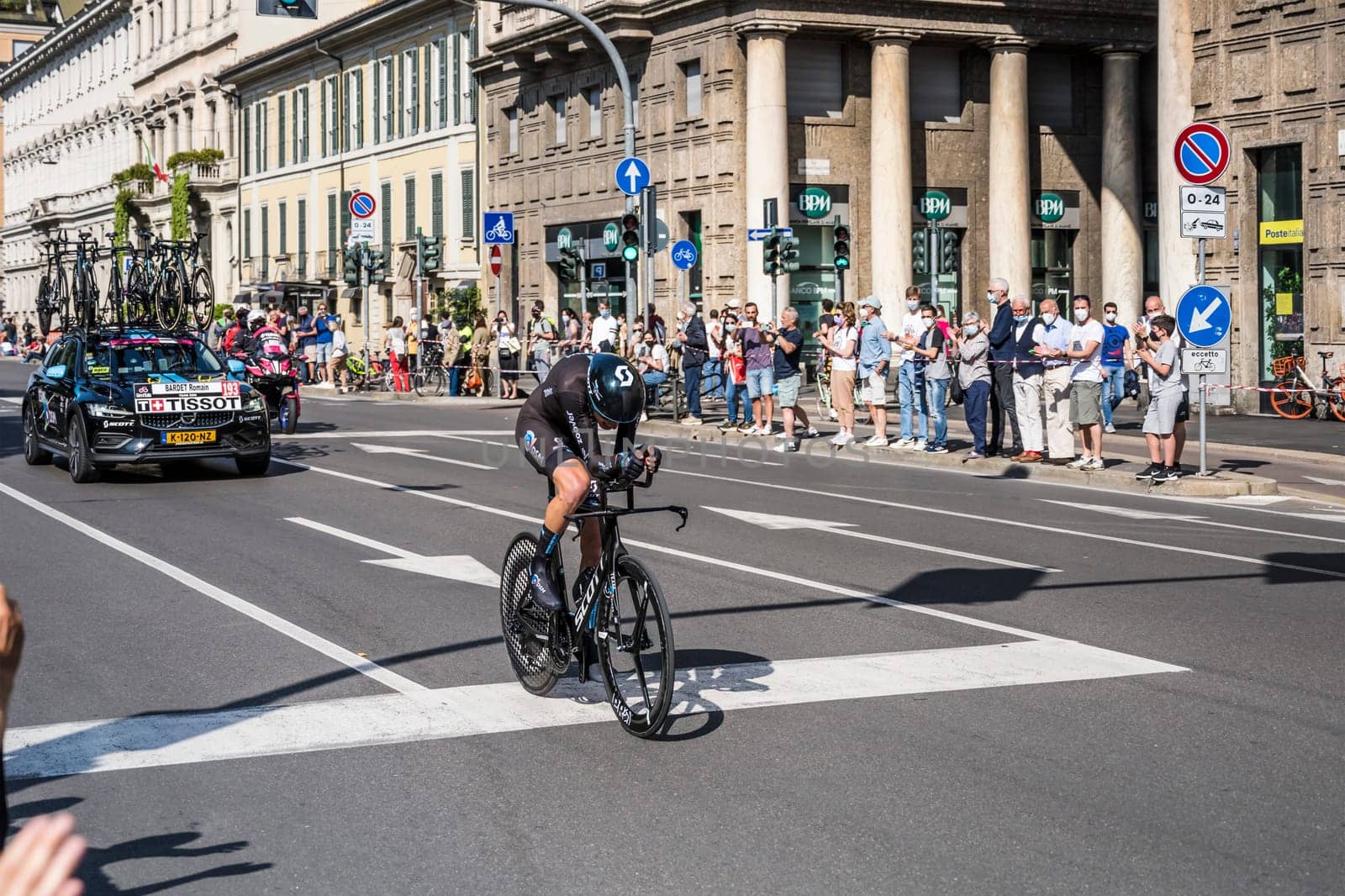 MILAN, ITALY - MAY 30: last stage of Giro 2021, Romain Bardet competitor and DSM following car at high speed during individual time trial in city streets, shot on may 30, 2021 Milan, Italy.