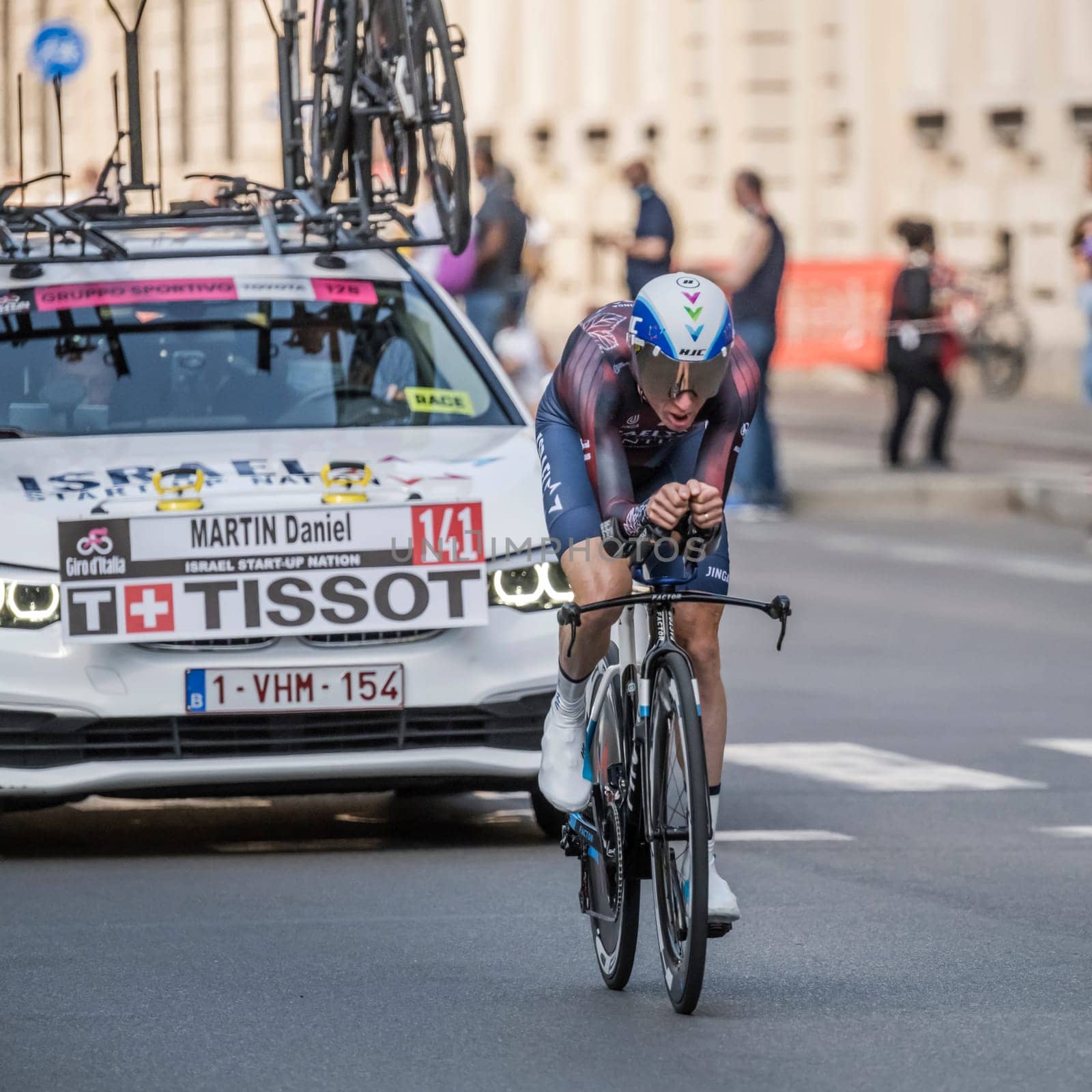 MILAN, ITALY - MAY 30: last stage of Giro 2021, Daniel Martin competitor and Isreal Start-up Nation Team following car at high speed during individual time trial in city streets, shot on may 30, 2021 Milan, Italy.