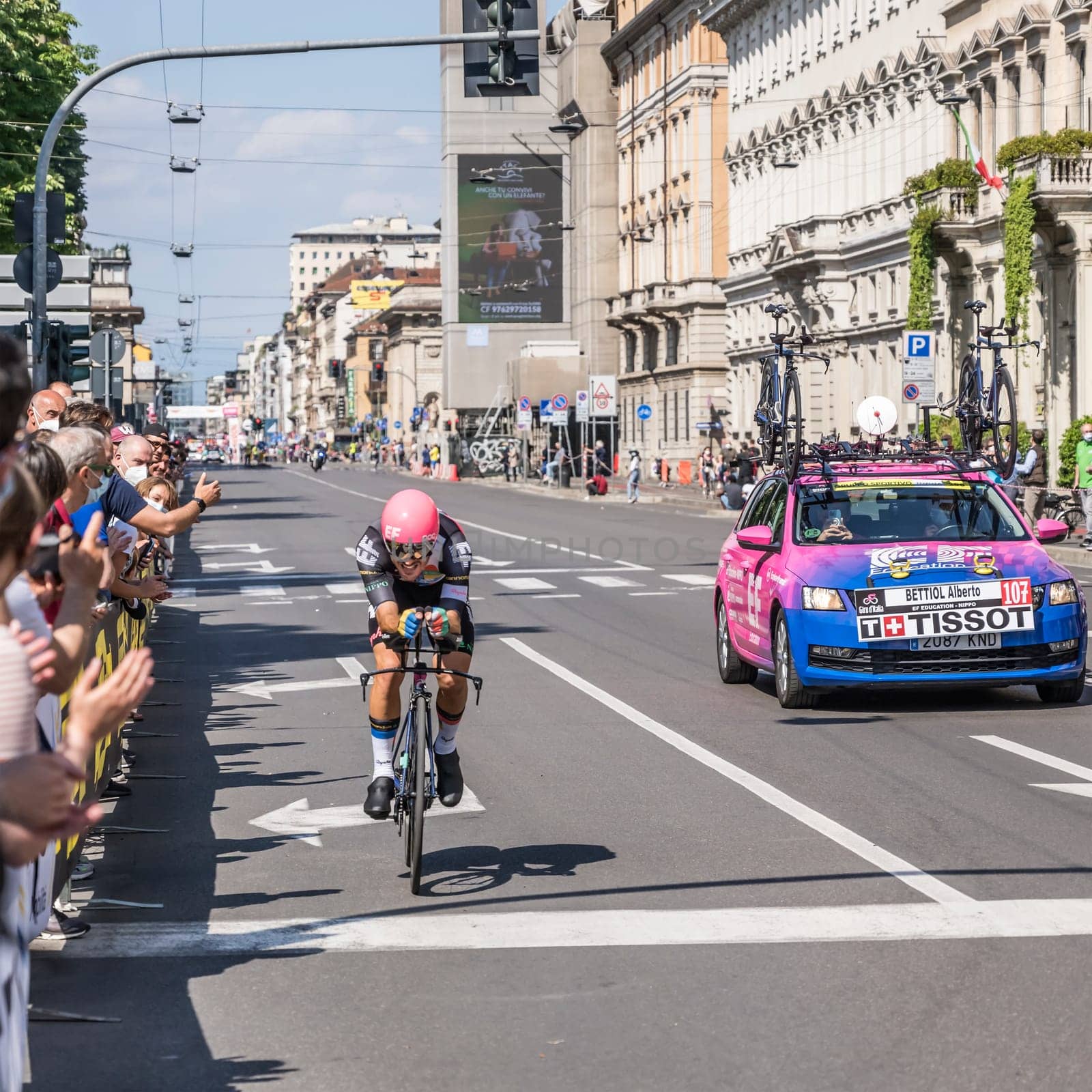 MILAN, ITALY - MAY 30: last stage of Giro 2021, Alberto Bettiol competitor and EF Education-Nippo Team following car at high speed during individual time trial in city streets, shot on may 30, 2021 Milan, Italy.