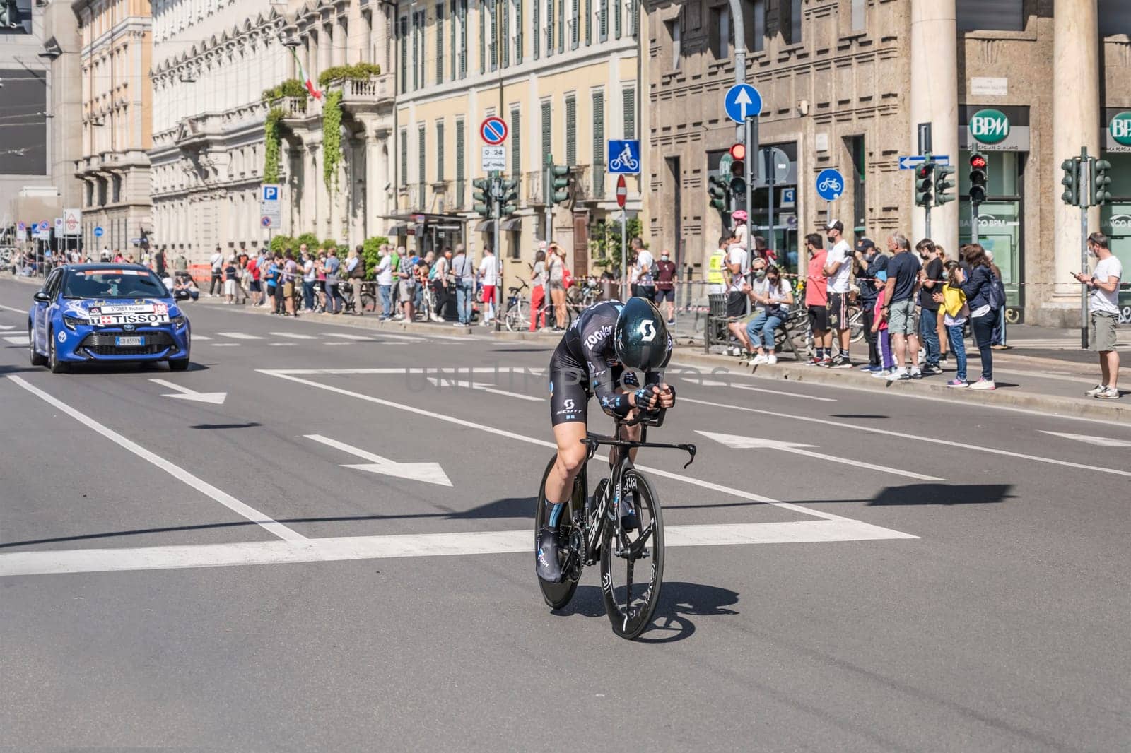 MILAN, ITALY - MAY 30: last stage of Giro 2021, Michael Storer competitor and DSM Team  following car at high speed during individual time trial in city streets, shot on may 30, 2021 Milan, Italy.