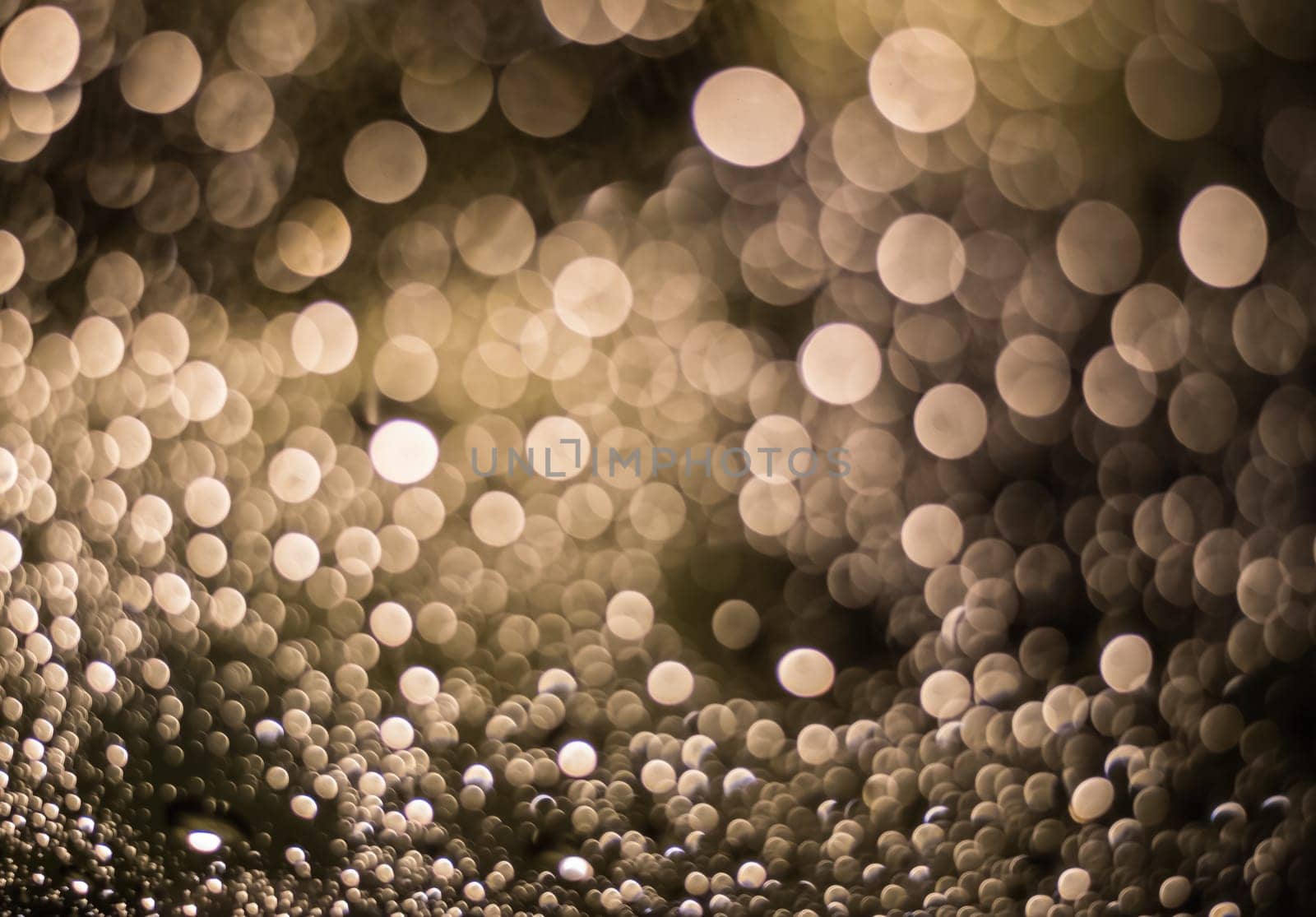 Abstract blurred dark brown light from water drop at the windscreen bokeh background