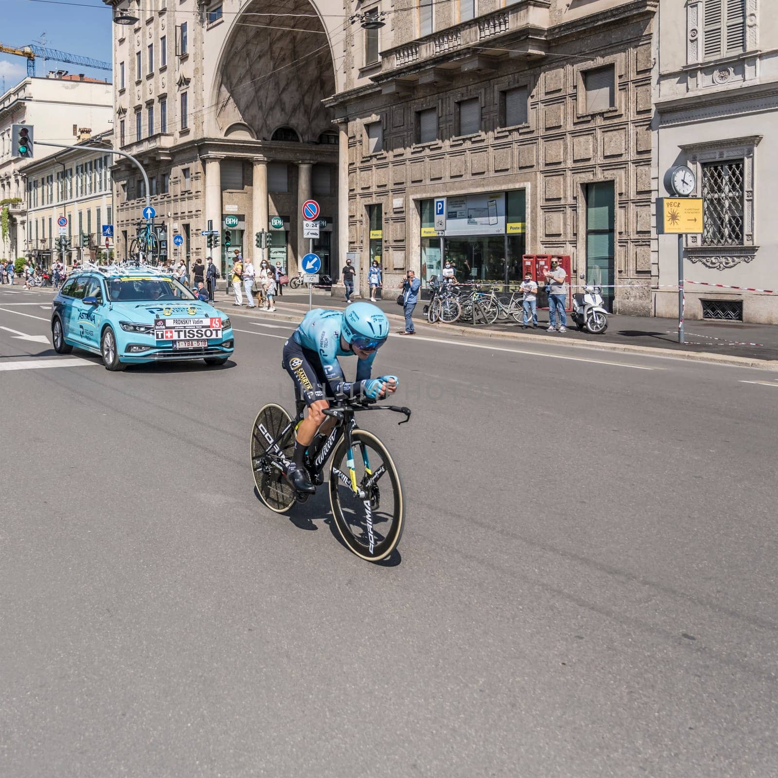 MILAN, ITALY - MAY 30: last stage of Giro 2021, Vladimir Pronskiy competitor and Astana Team following car at high speed during individual time trial in city streets, shot on may 30, 2021 Milan, Italy.
