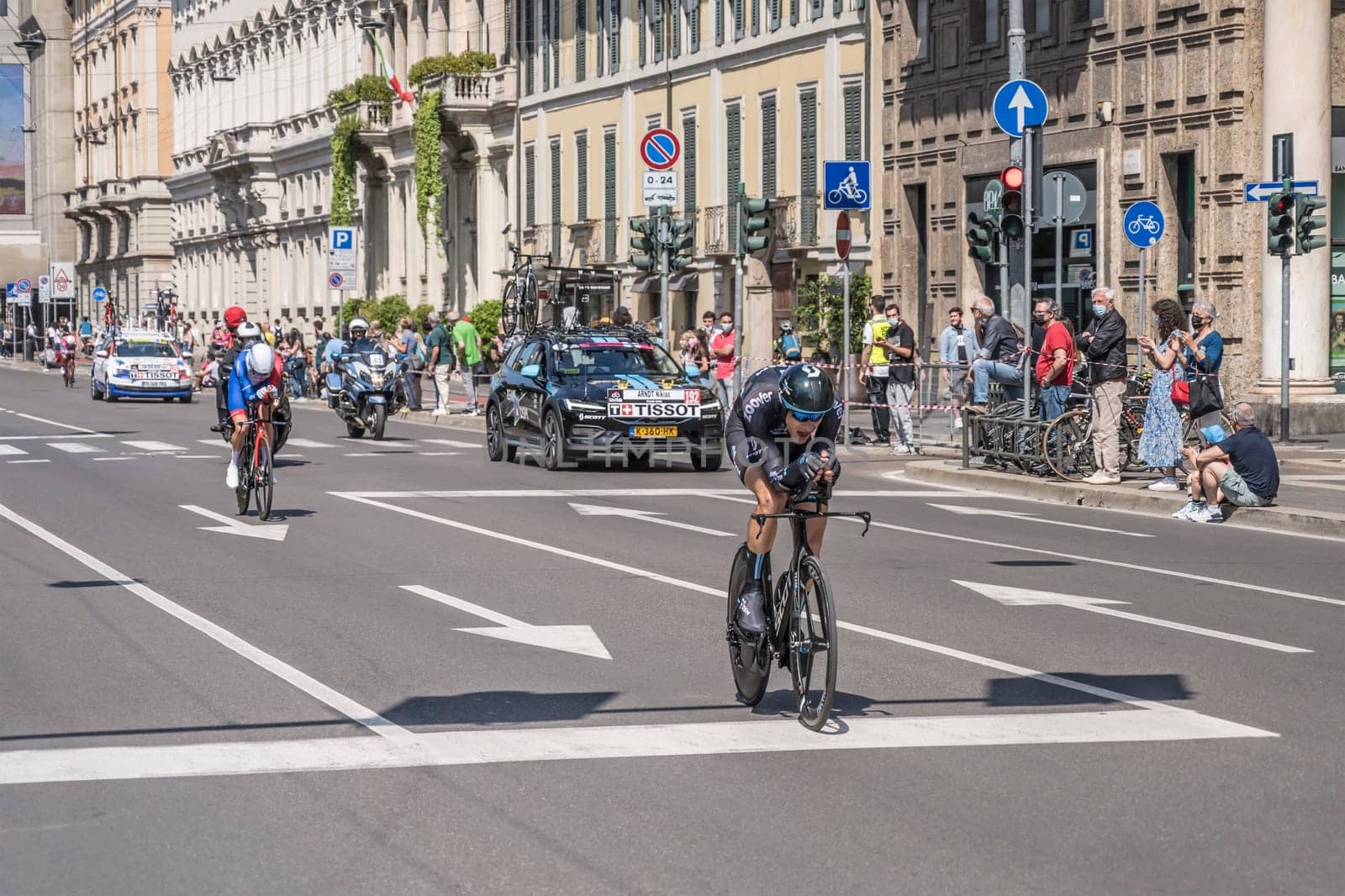 MILAN, ITALY - MAY 30: last stage of Giro 2021, Nikias Arndt competitor of DSM Team and Lars Van Den Berg of Groupama Team  at high speed during individual time trial in city streets with their following cars behind, shot on may 30, 2021 Milan, Italy.