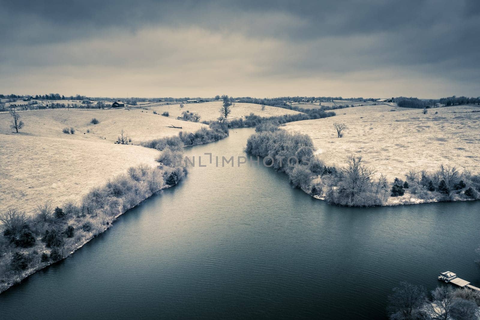 Fresh snow on shores of a small lake in Central Kentucky. Aerial view.