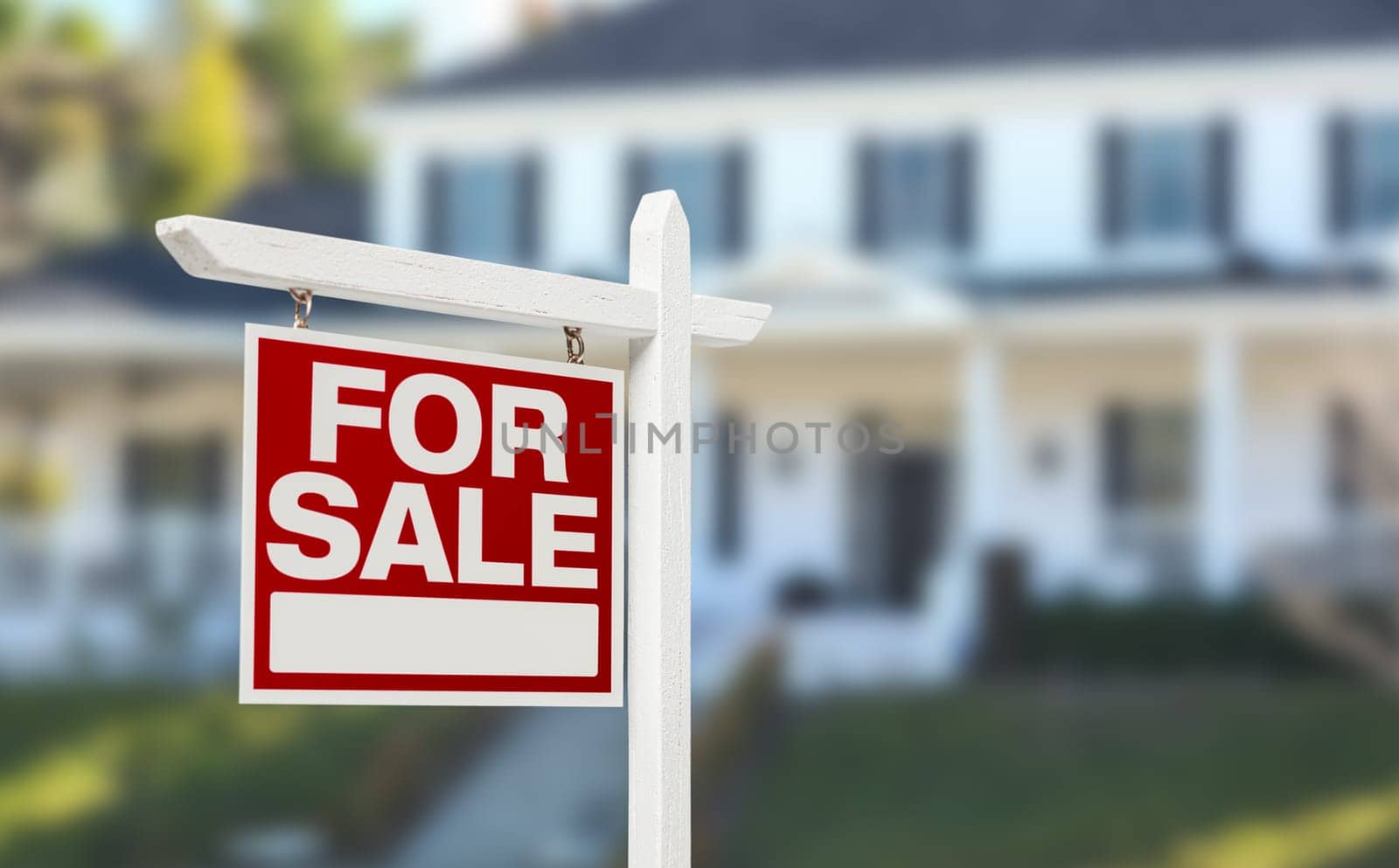Home For Sale Real Estate Sign in Front of Beautiful New House.