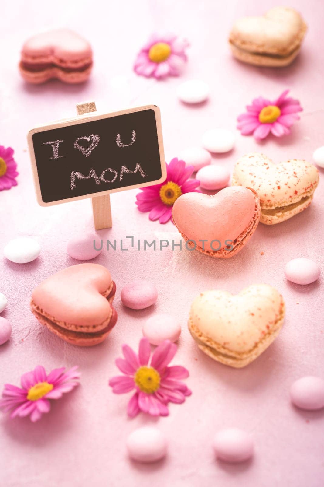 Happy Mothers Day - sweet macarons in heart shape with flowers in pink tone with text I love you Mum