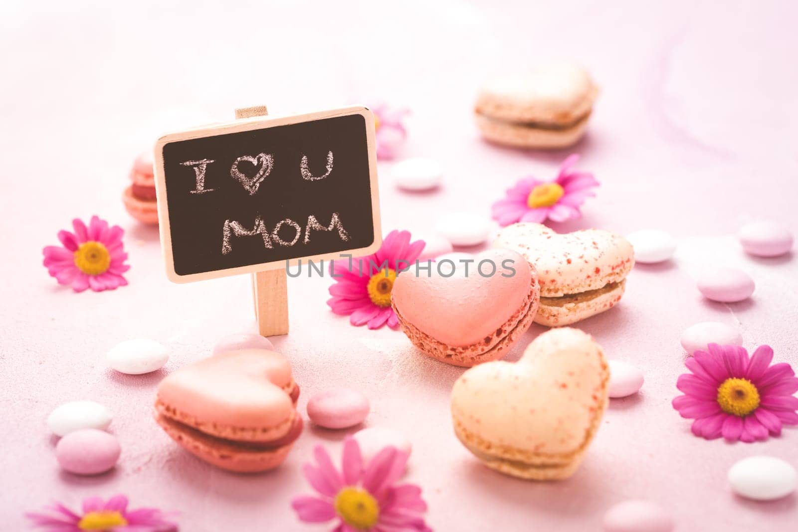 Happy Mothers Day - sweet macarons in heart shape with flowers in pink tone with text I love you Mum