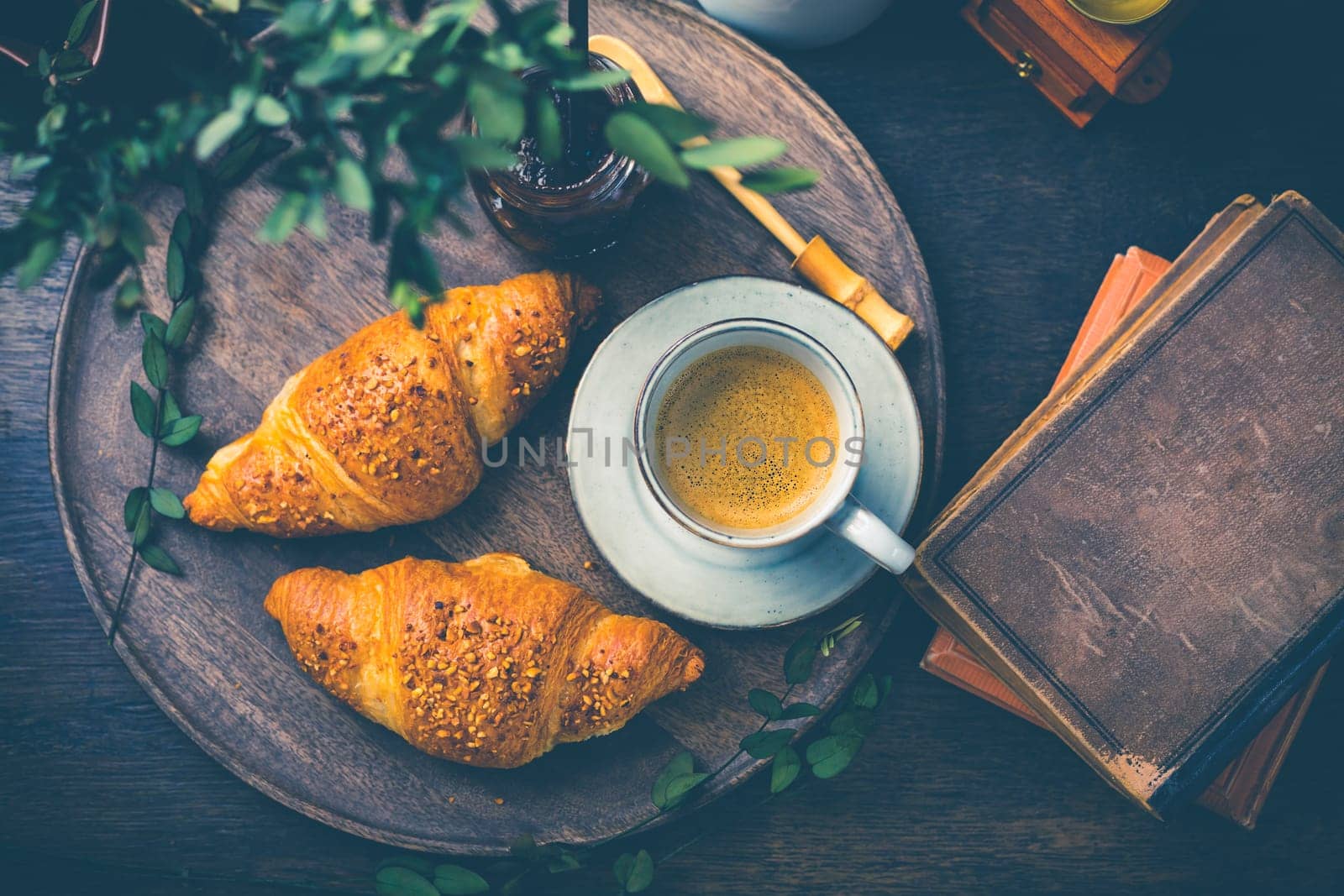 Breakfast - Croissants with nuts and cup of coffee on morning table