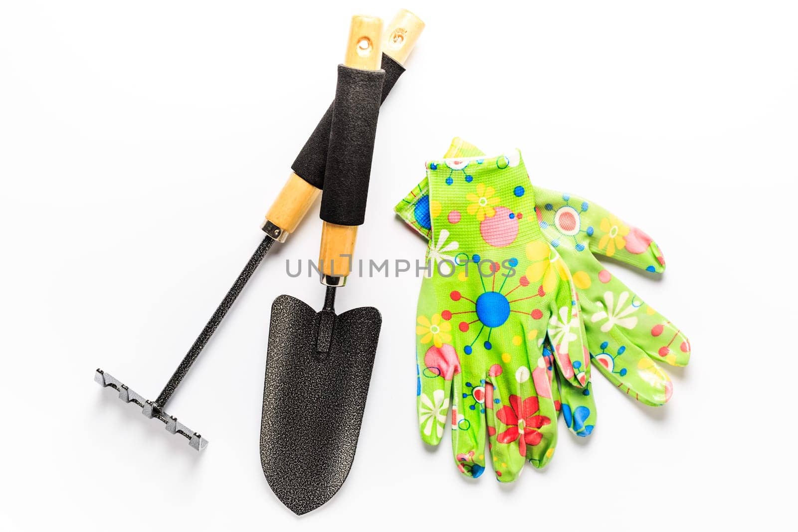 Garden tools with garden gloves on white background. Gardening concept.