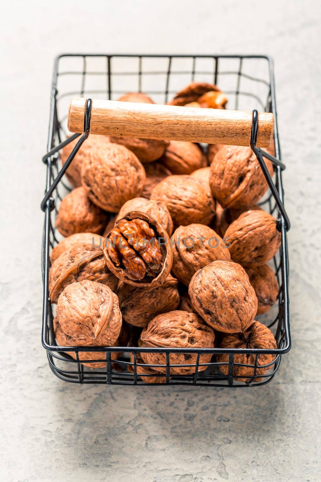 Organic walnuts in basket on kitchen table.