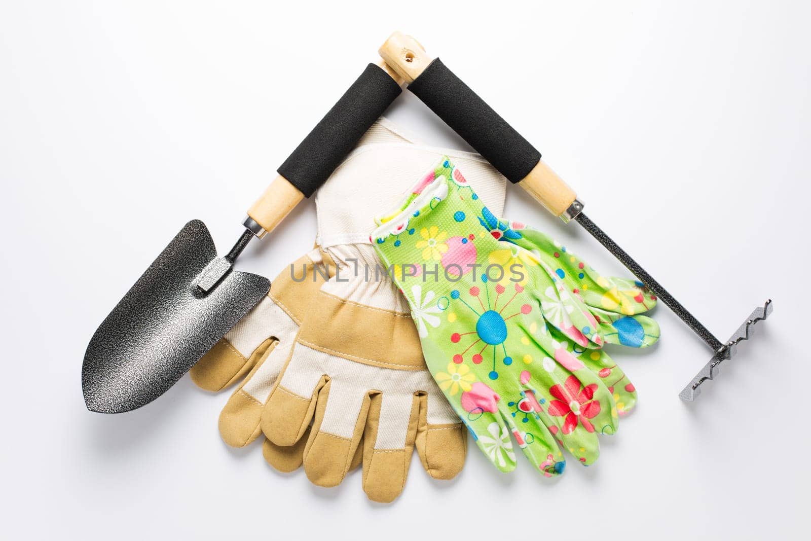 Garden tools with garden gloves on white background. Gardening concept.