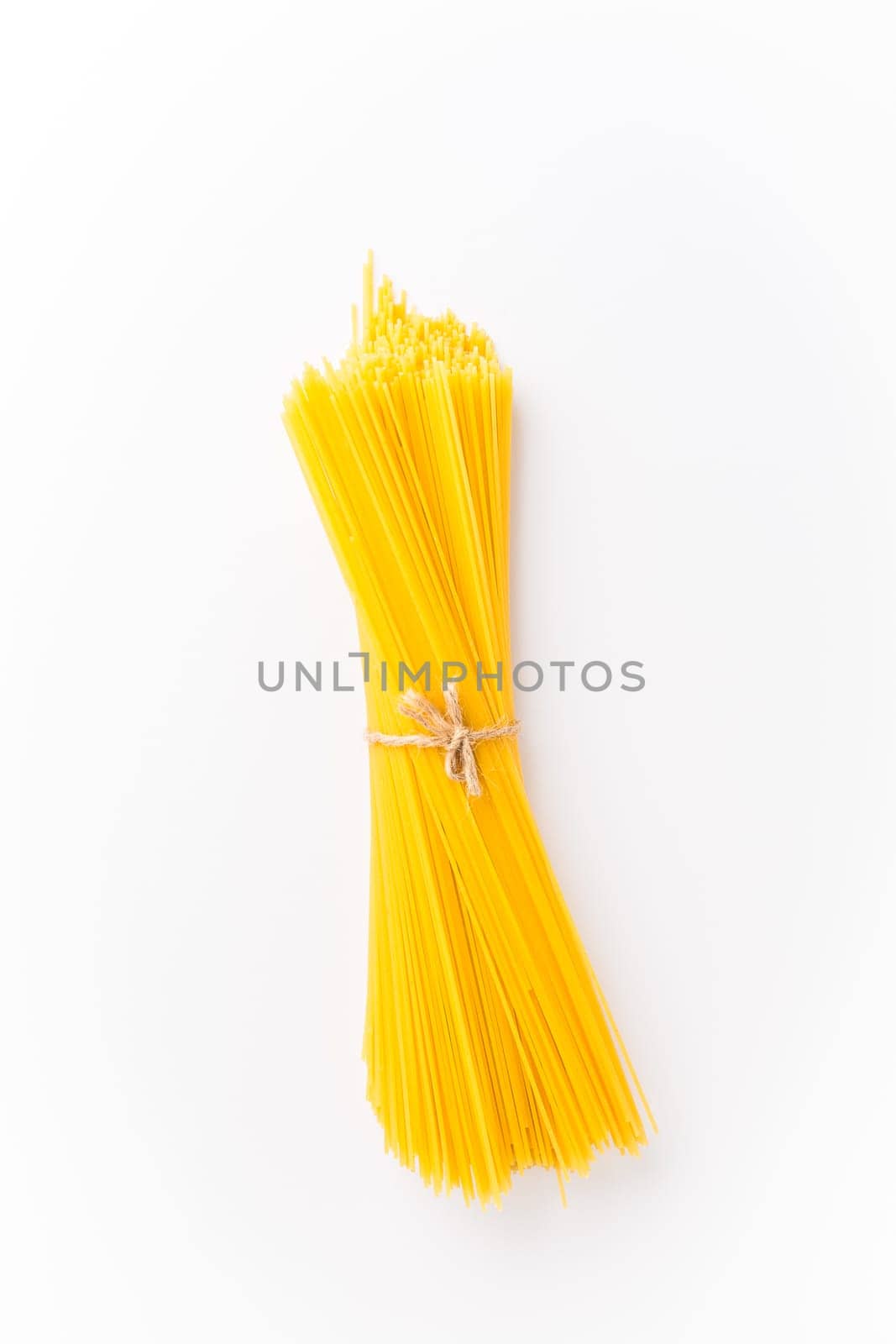 Spaghettini - thinner Spaghetti. Raw Spaghetti on white background.