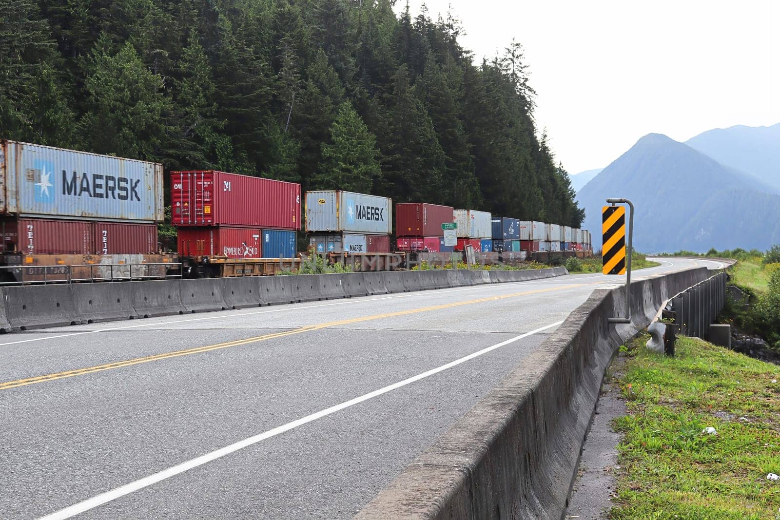 BASALT CREEK, CANADA - AUGUST 8, 2019: a railway train carries containers full of items from the west coast, British Columbia, Canada.