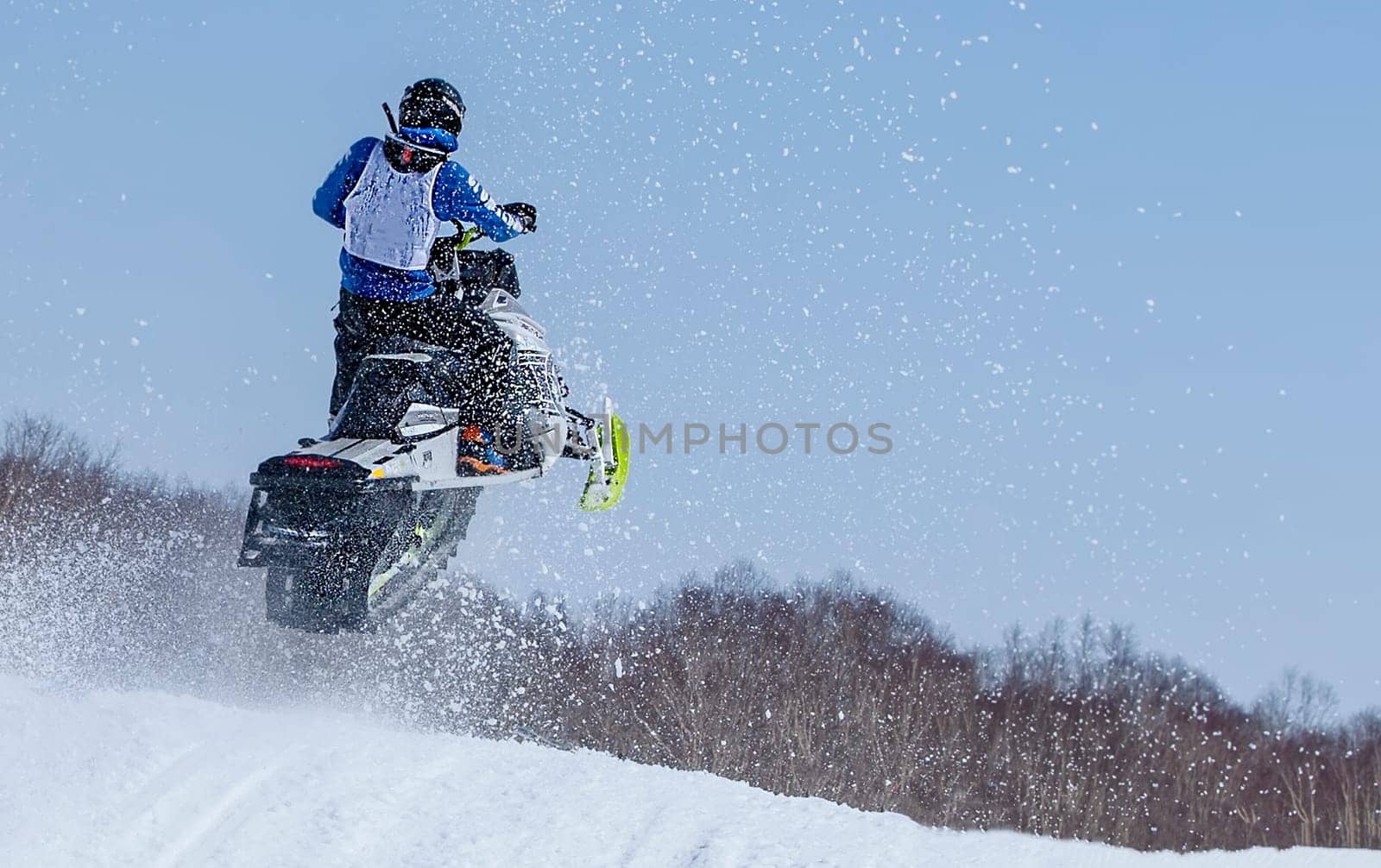 The Snowmobile in high jump above track.