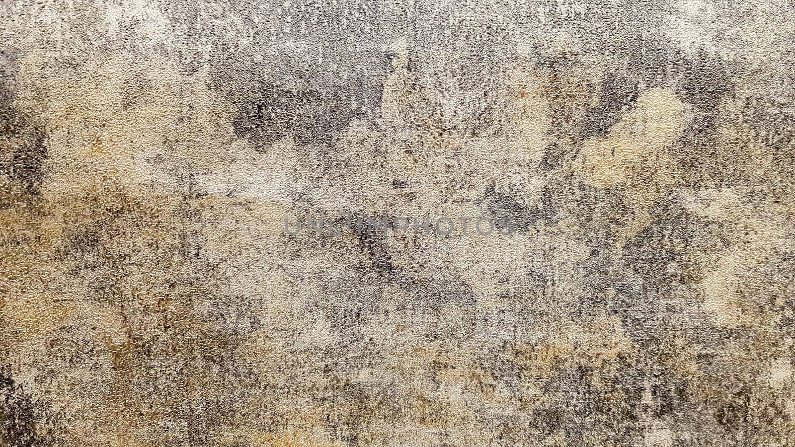 Brown, gray and gold dirty concrete wall plaster texture. Decorative paint for walls or grunge style background. Decorative plaster