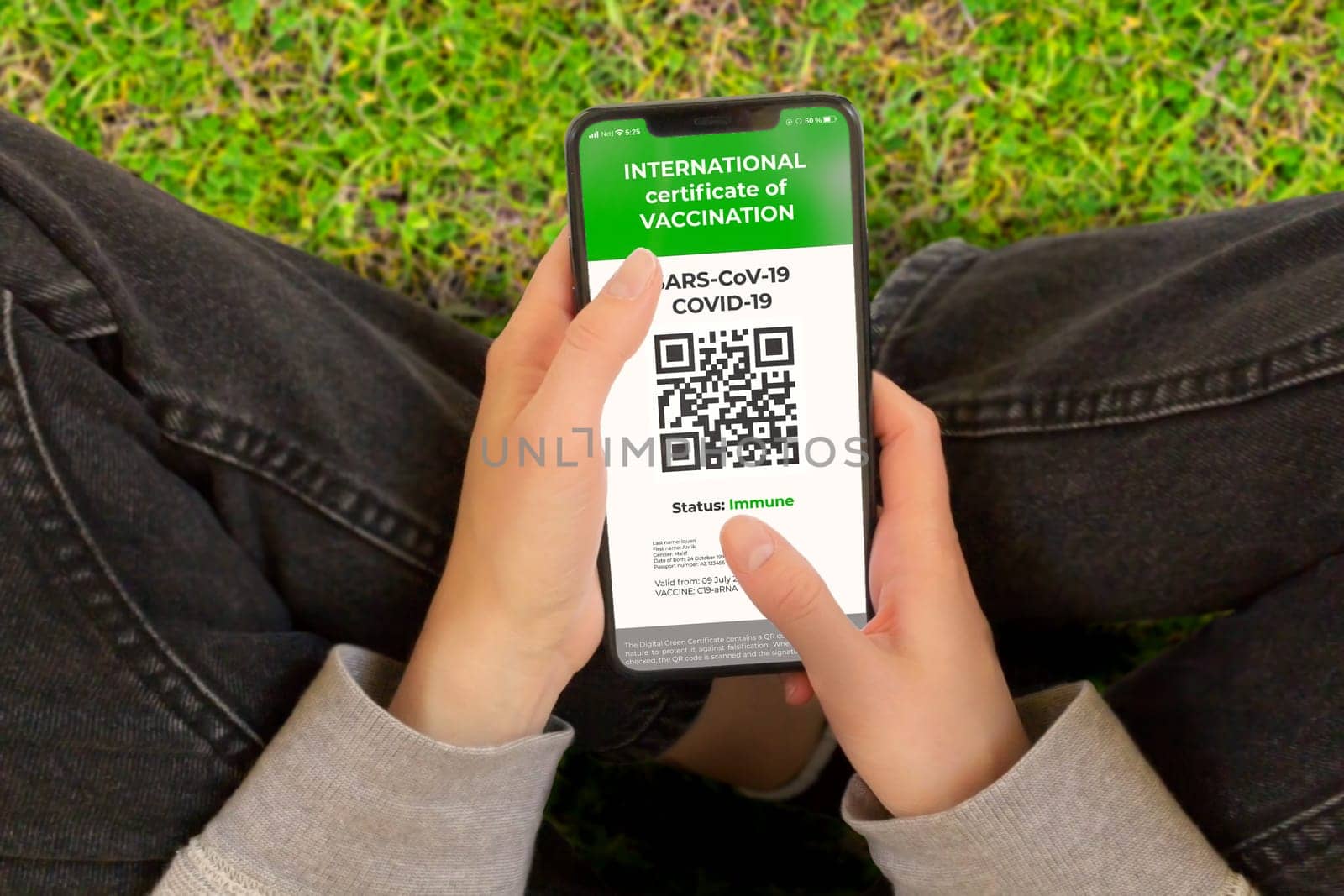 COVID-19: Digital green certificates or Covid Digital vaccine certificate on Cellphone Screen. Young Girl Takes Smartphone with Vaccinated digital health passport.
