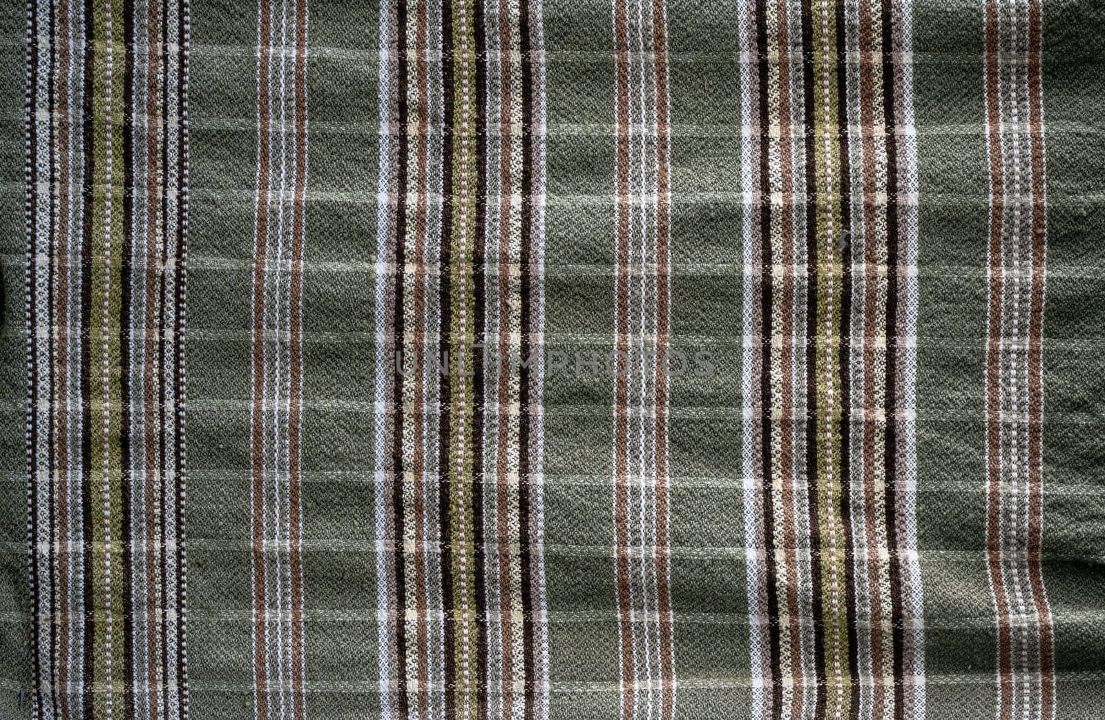 front view closeup of wrinkled cotton towel with woven texture of traditional motifs