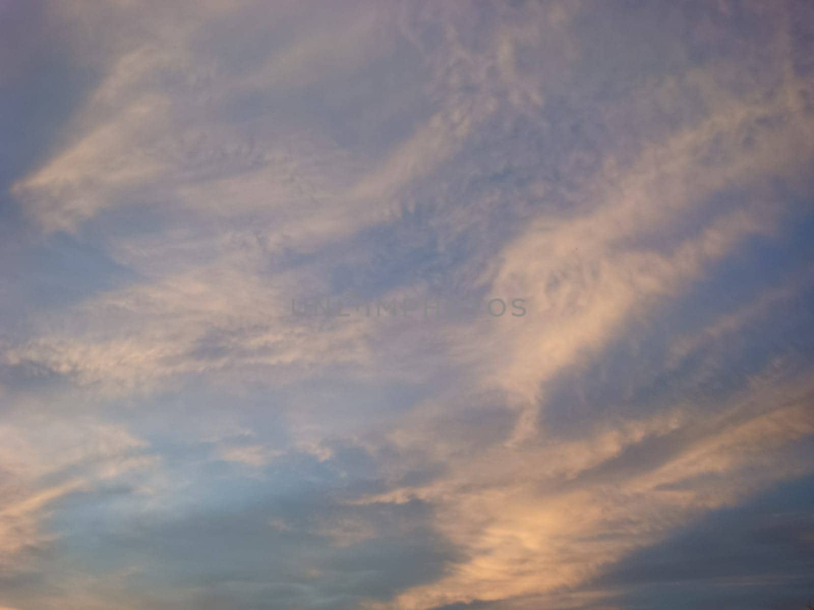 The sky with the clouds at sunset. The light of the sunset on the clouds. sky in the evening.