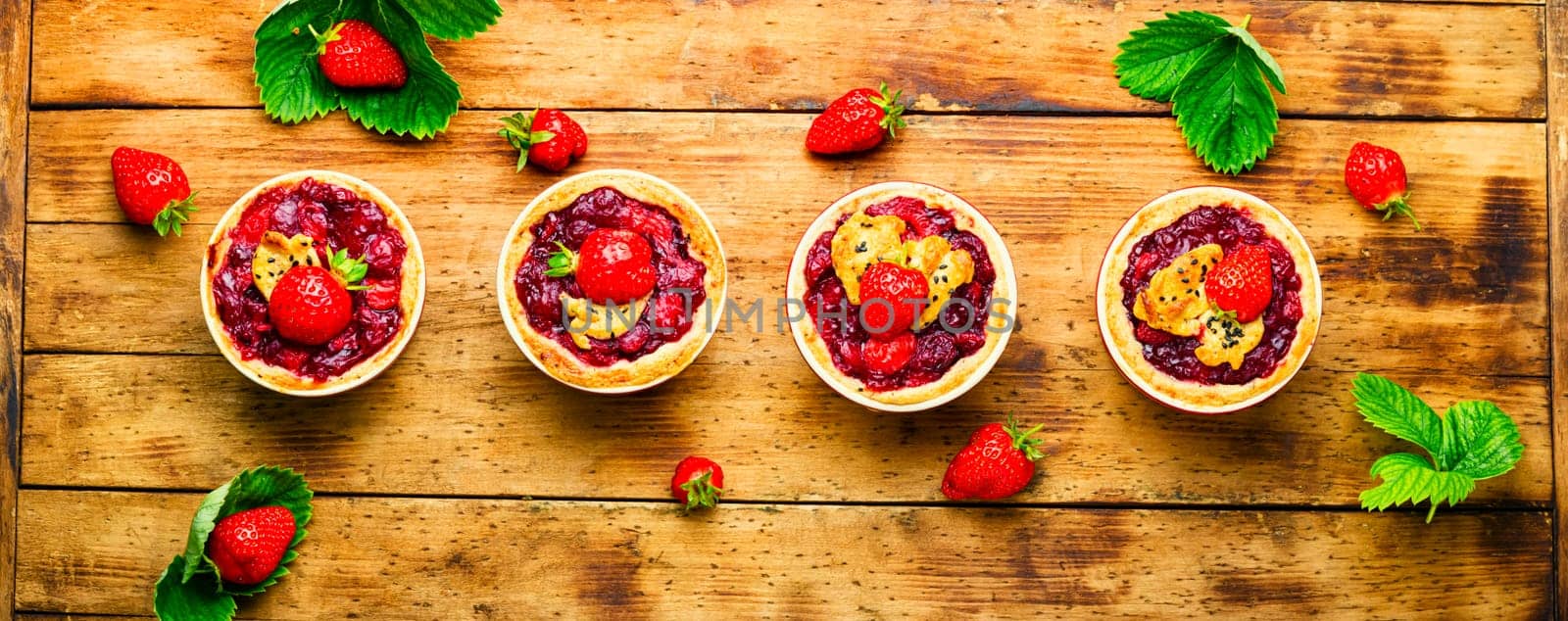 Delicious tartlets with berry jam.Cake with strawberries.