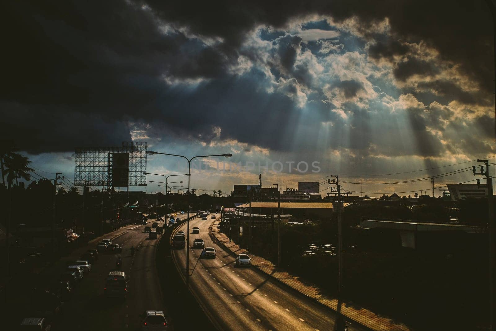 August 2019,Bangkok Thailand  Sun rays shining thru dramatic clouds scanning city of Bangkok below s.God message concept idea. Nature spiritual background. Traffic in city