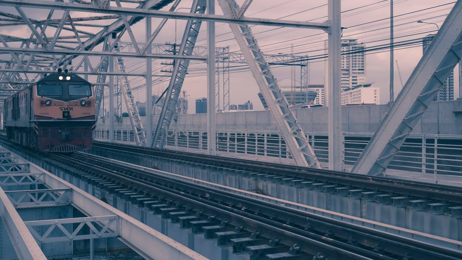 Bangkok Thailand ,Augest 2019 Old vintage train in Thailand riding on iron bridge across river in Bangkok.