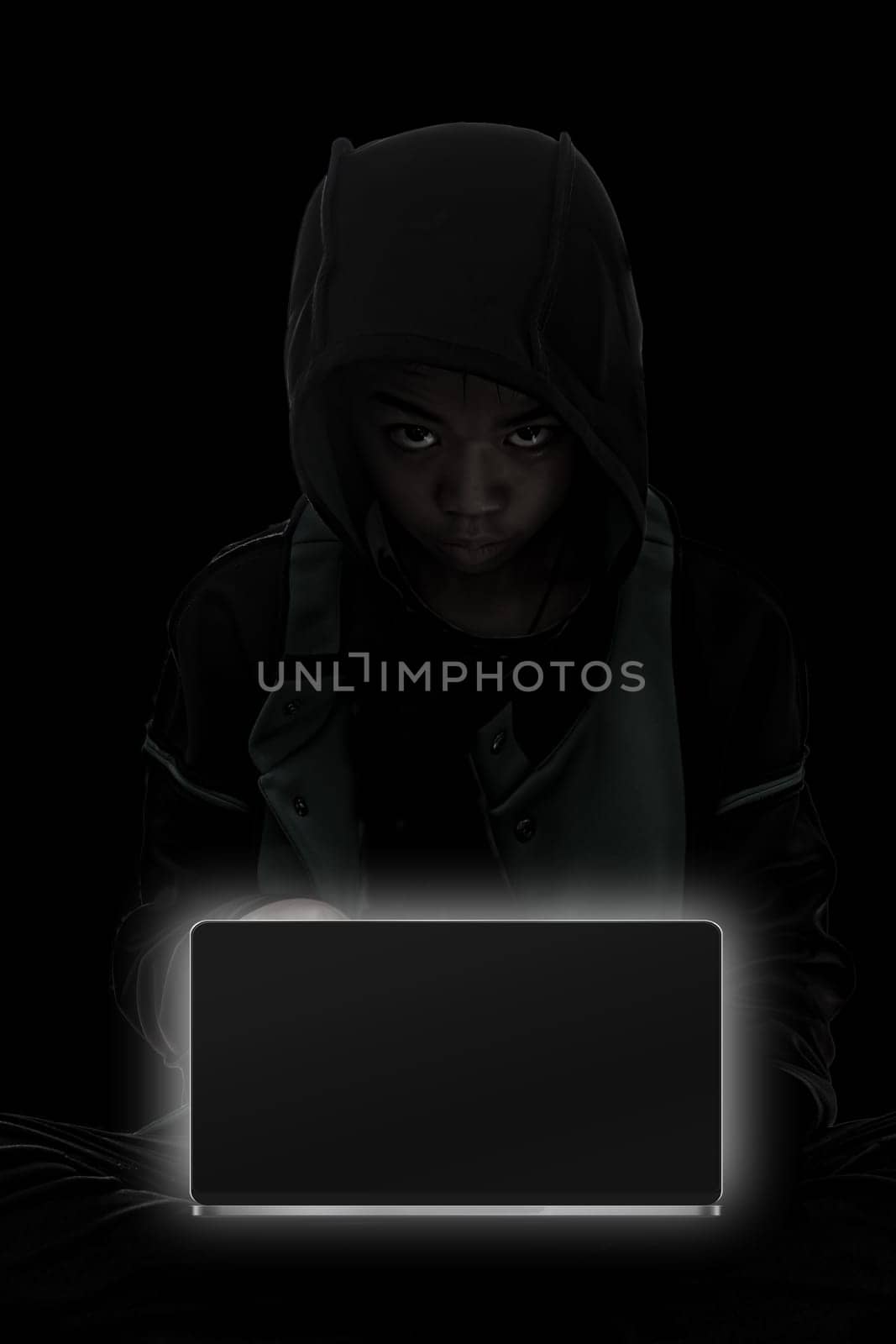 Hacker boy are hacking through the laptop on a black background.