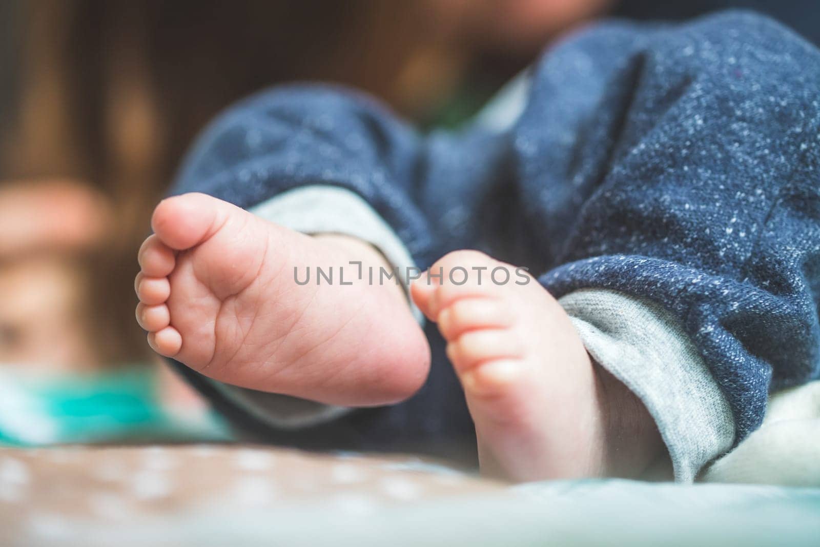 Close up of newborn baby feet on baby blanket