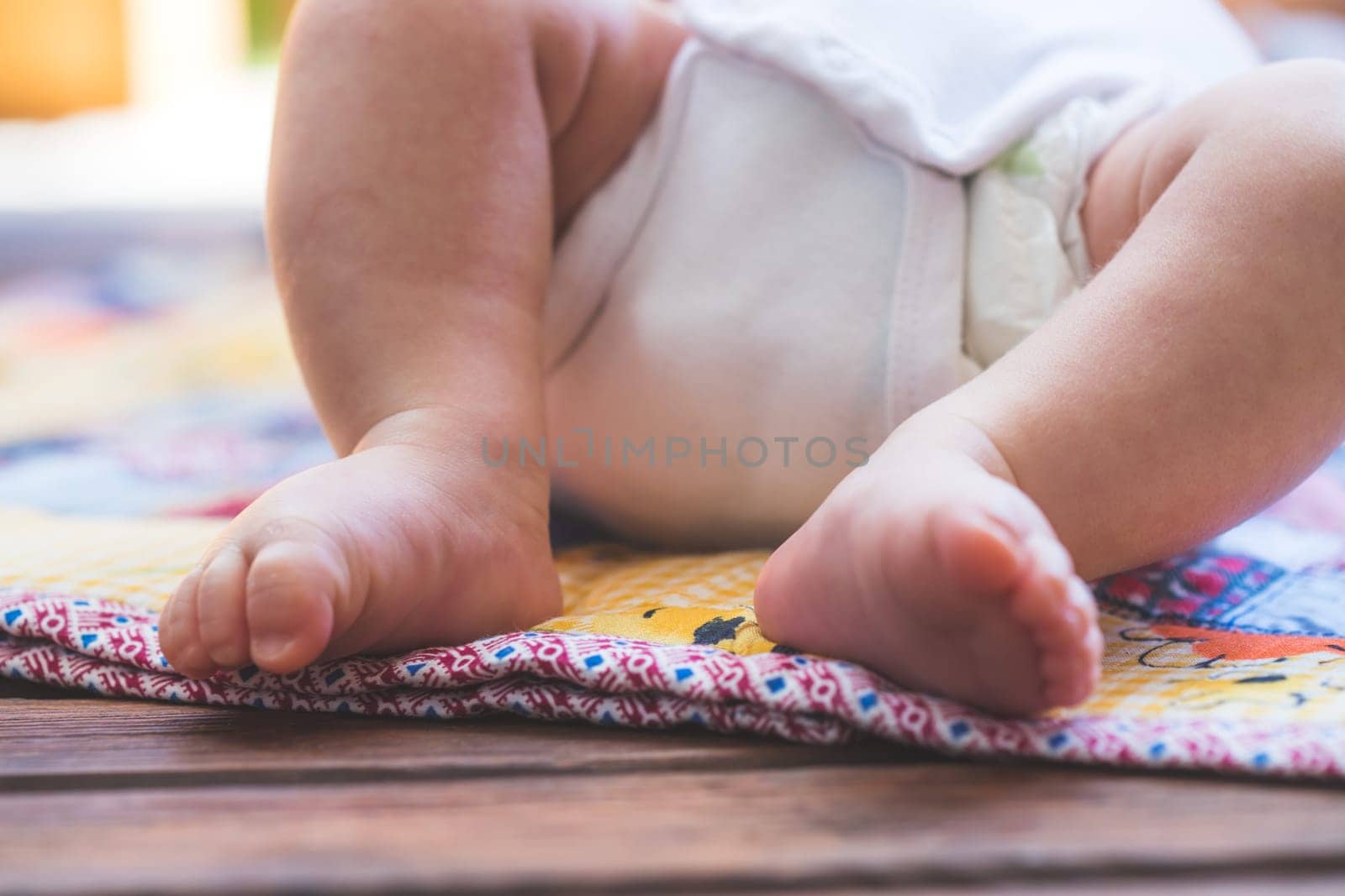 Close up of newborn baby feet, outdoors on baby blanket