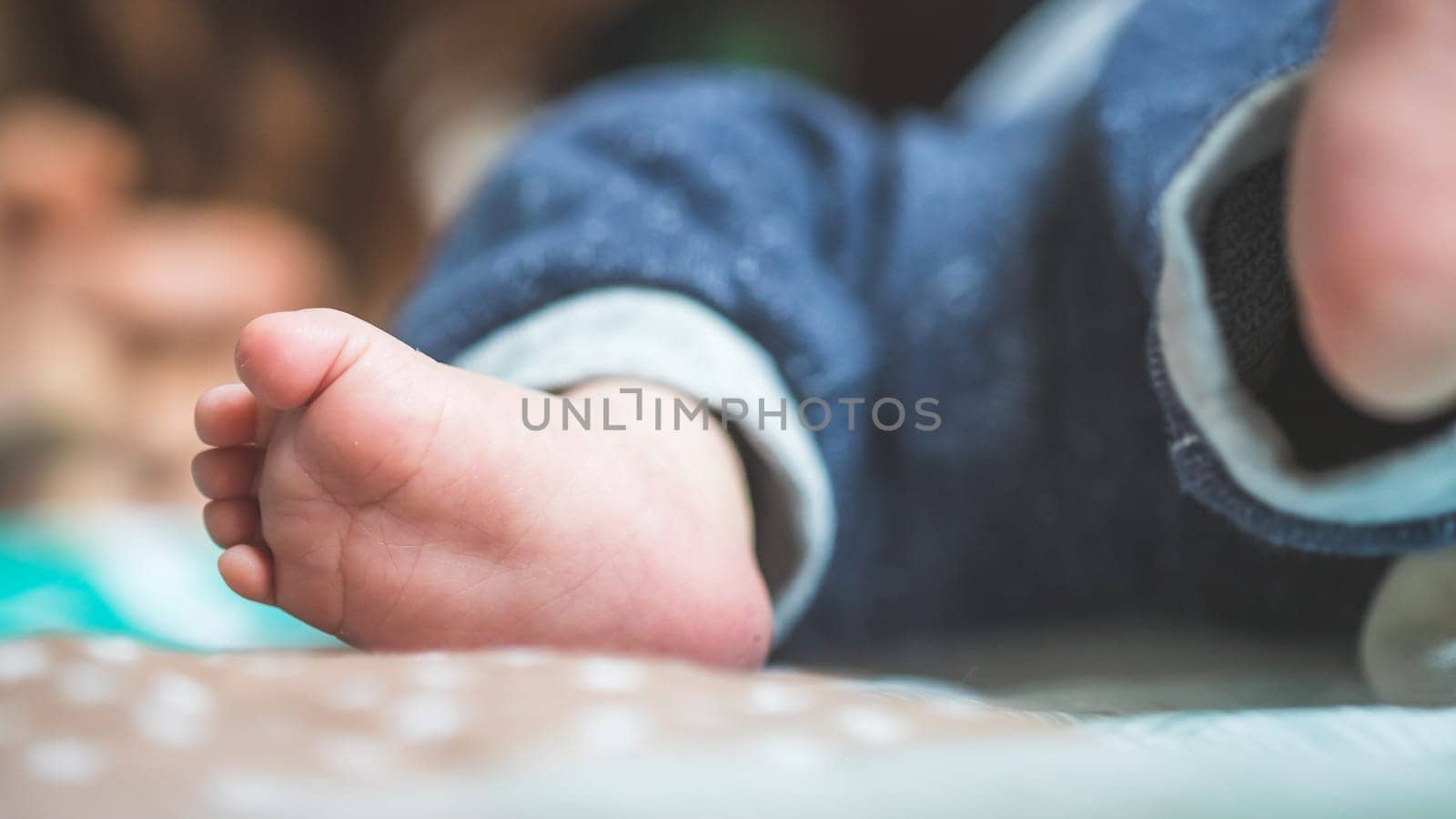 Close up of newborn baby feet on baby blanket