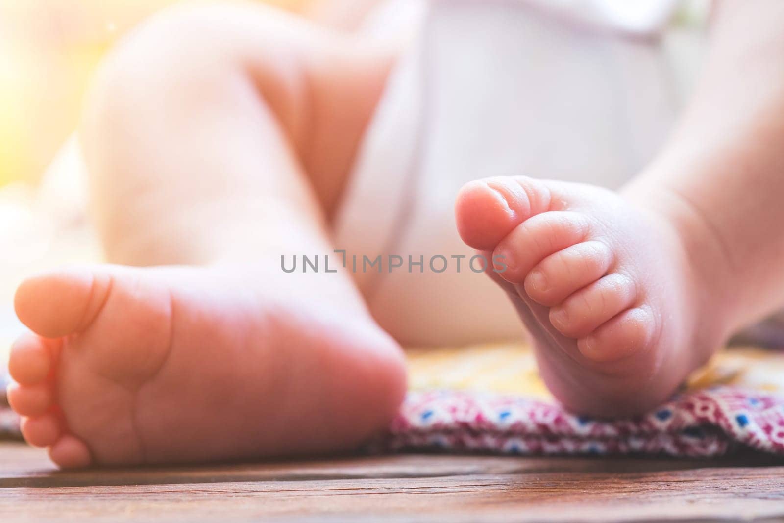 Close up of newborn baby feet, outdoors on baby blanket