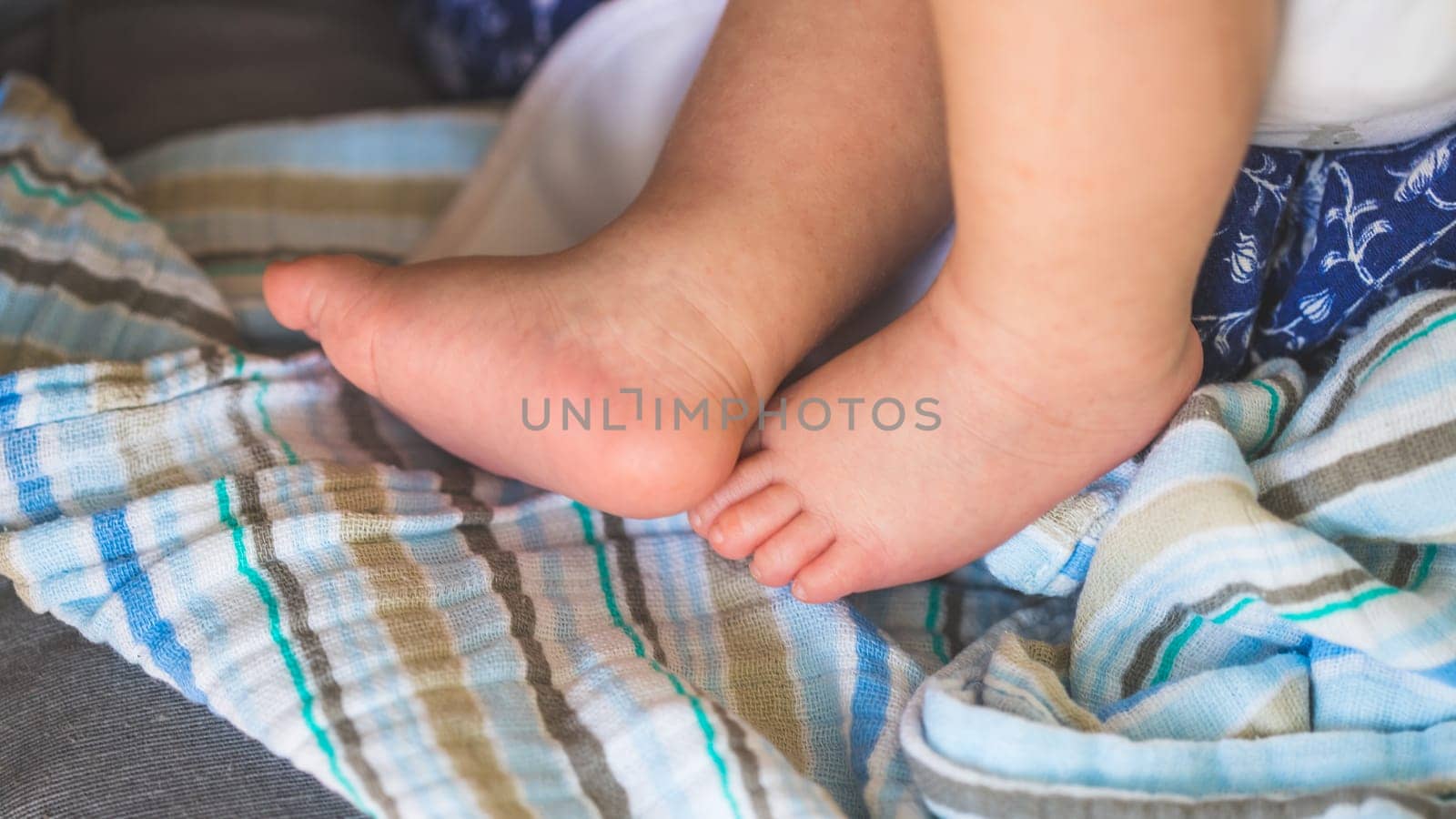 Close up of newborn baby feet on baby blanket